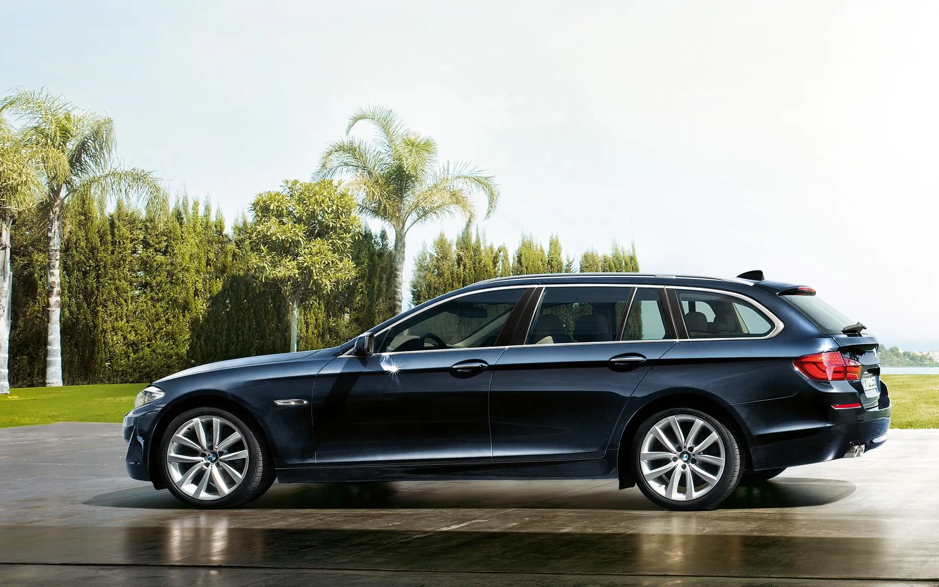 Black Bmw Station Wagon Parked in Sunny Garden Image
