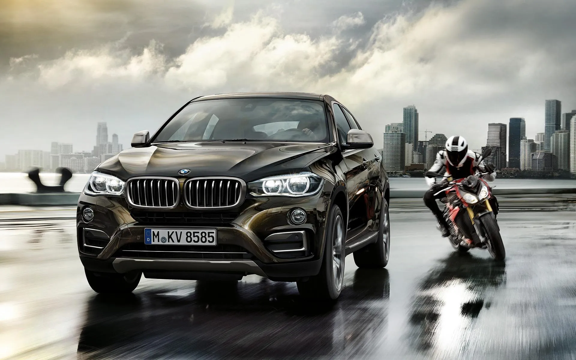 Black Bmw Suv and Biker Racing in Wet City Street Scene