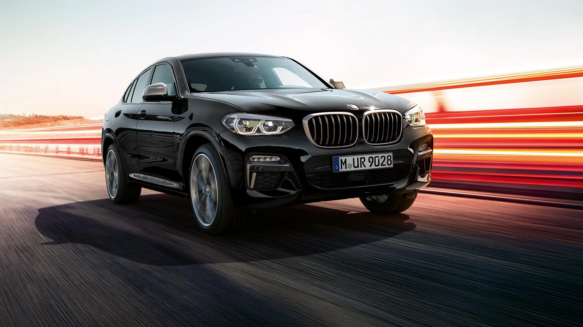 Black Bmw Suv Driving Fast on a Coastal Sunset Highway