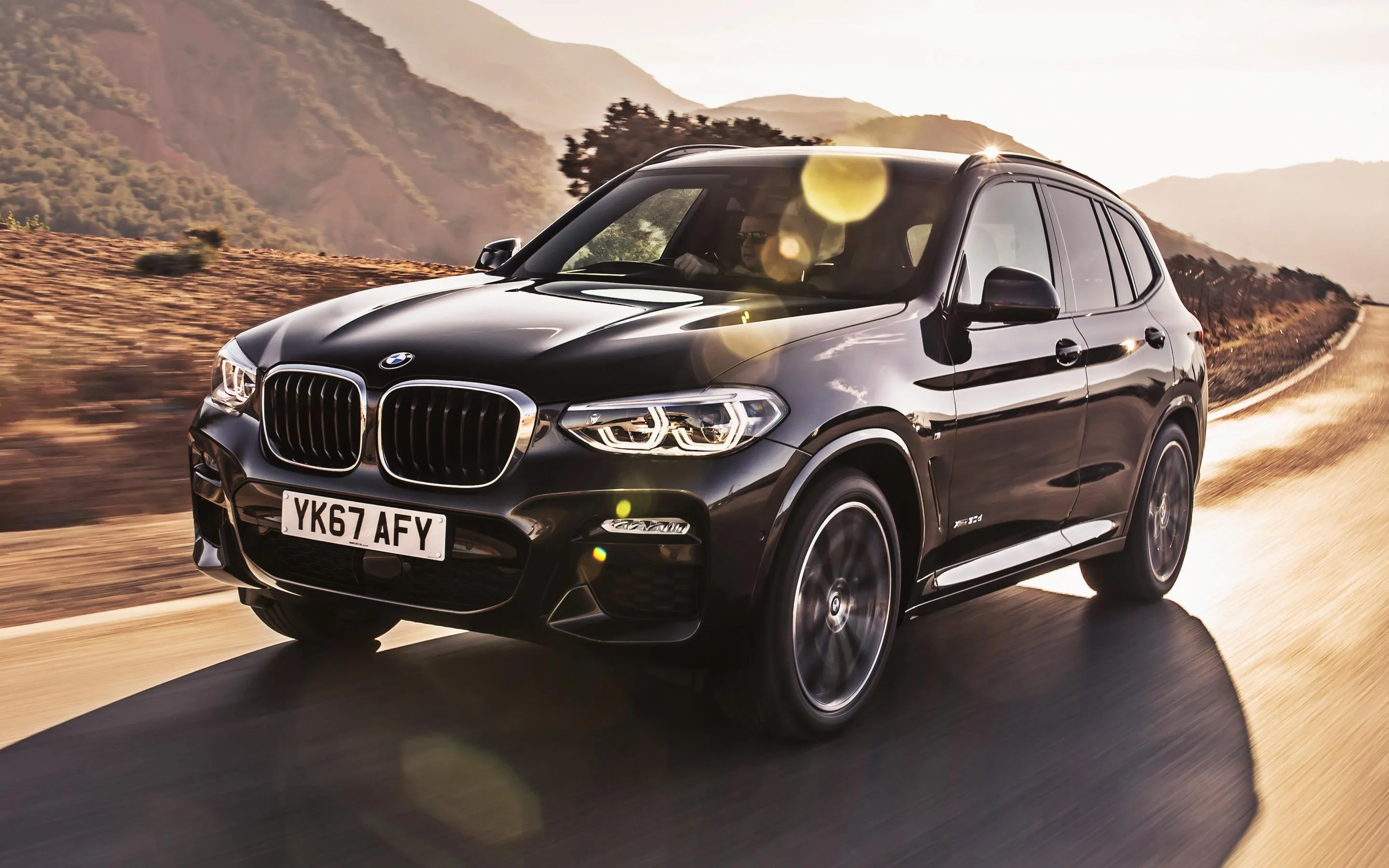 Black Bmw Suv Driving on Curvy Desert Mountain Road