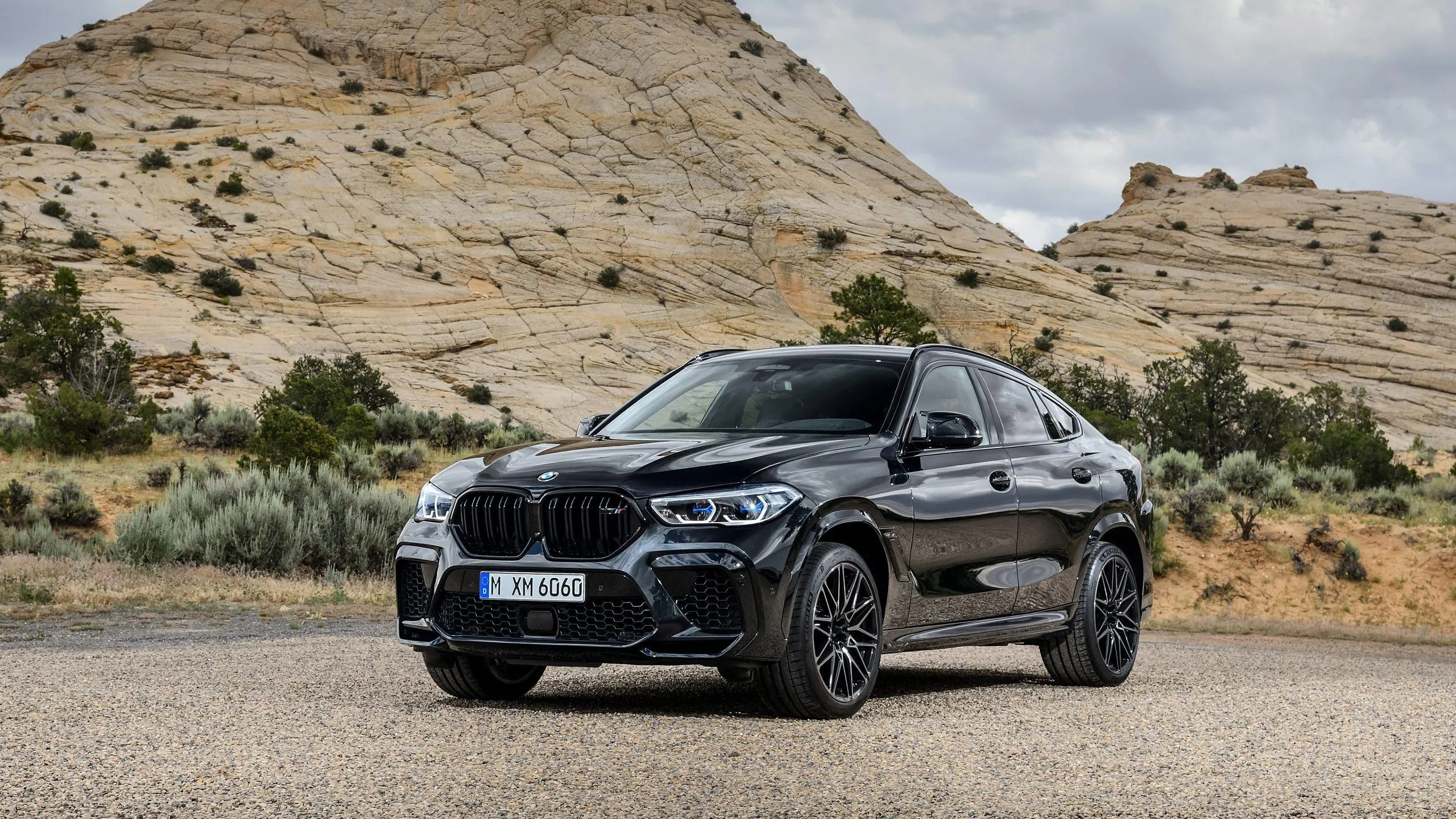 Black Bmw Suv Offroading on Rocky Desert Terrain Wallpaper