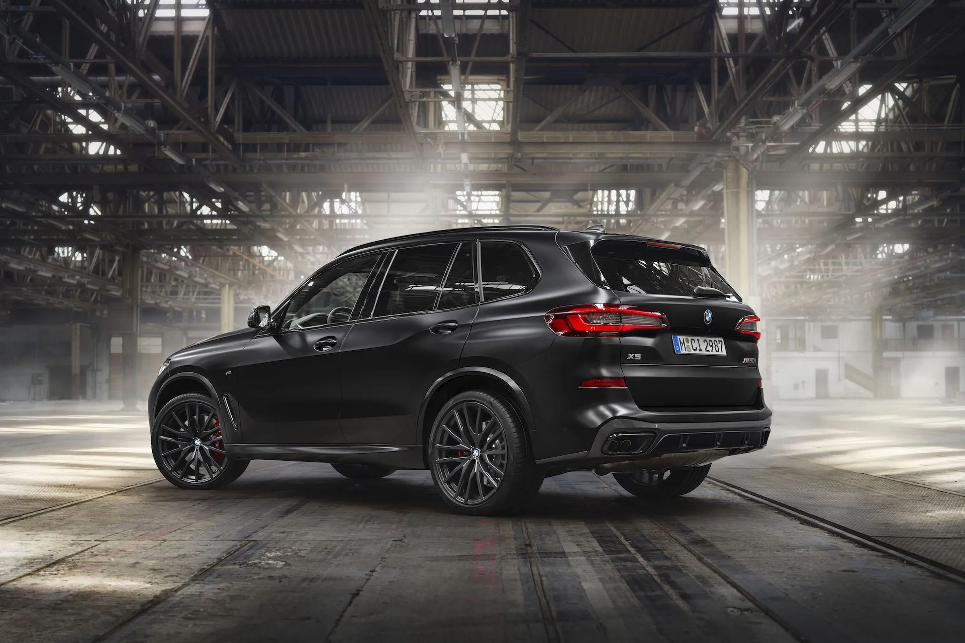 Black Bmw Suv Parked in a Dimly Lit Industrial Setting