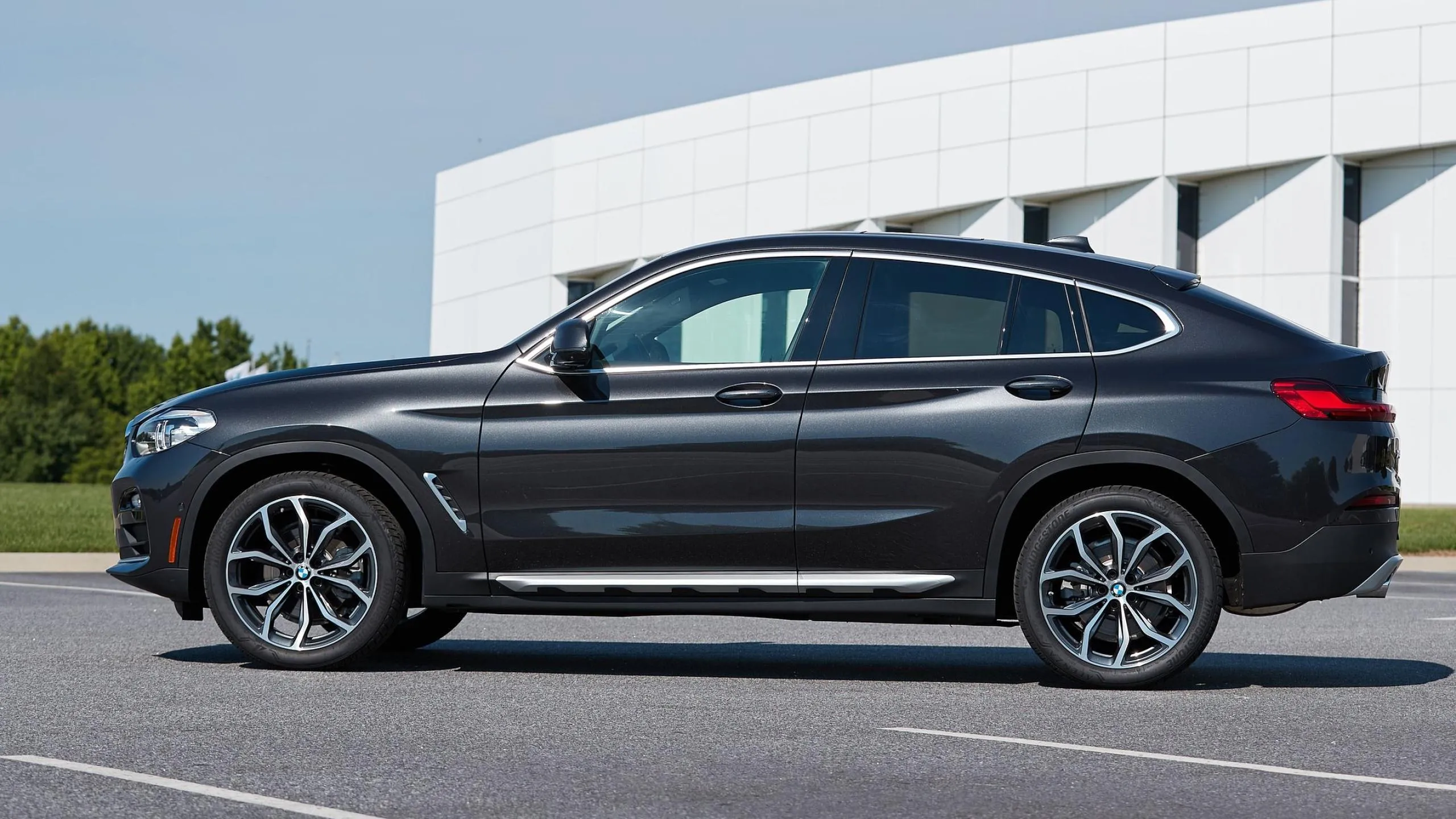 Black Bmw Suv Parked in Urban Area Near White Building