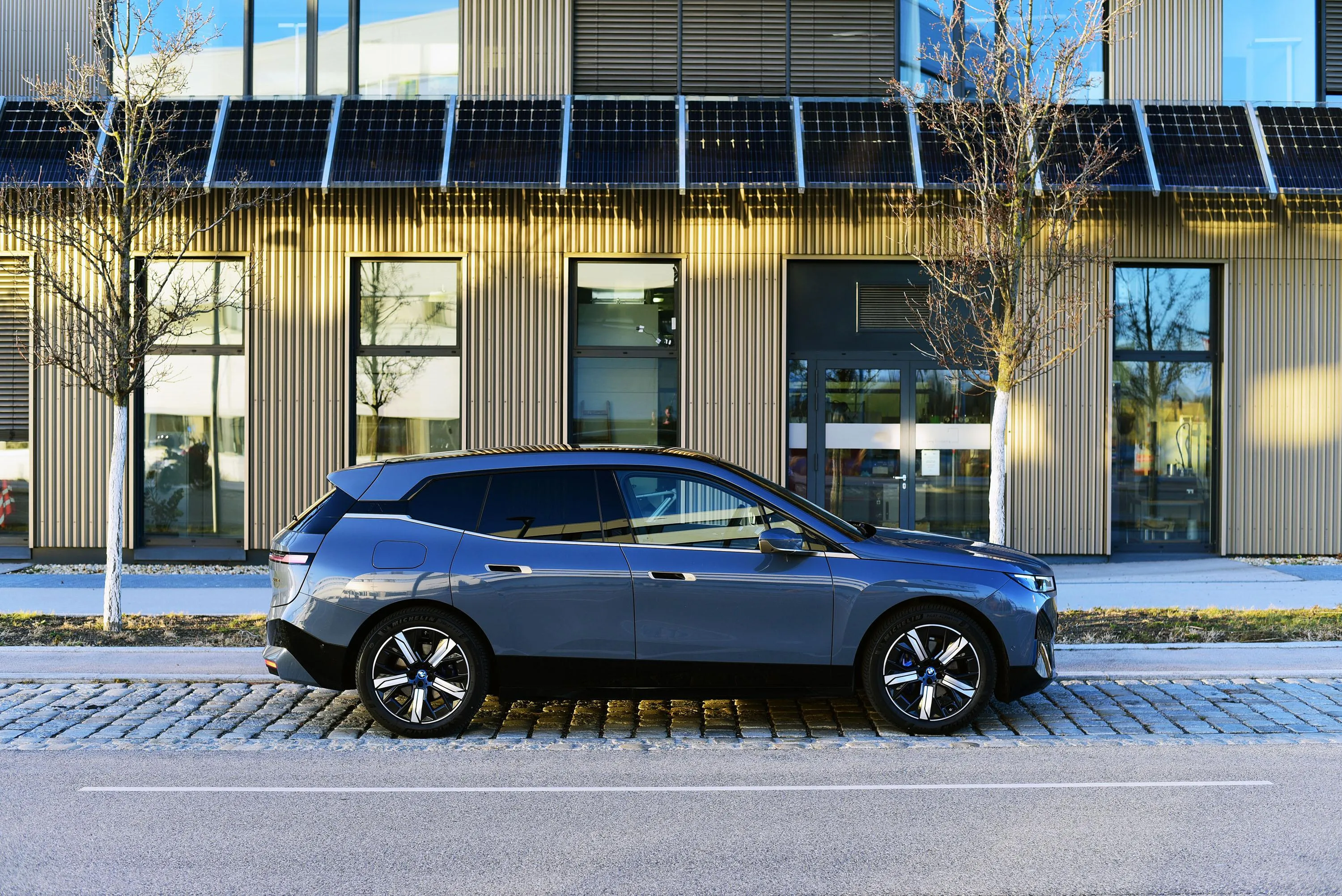 Black Bmw Suv Parked Outside a Modern Office Building