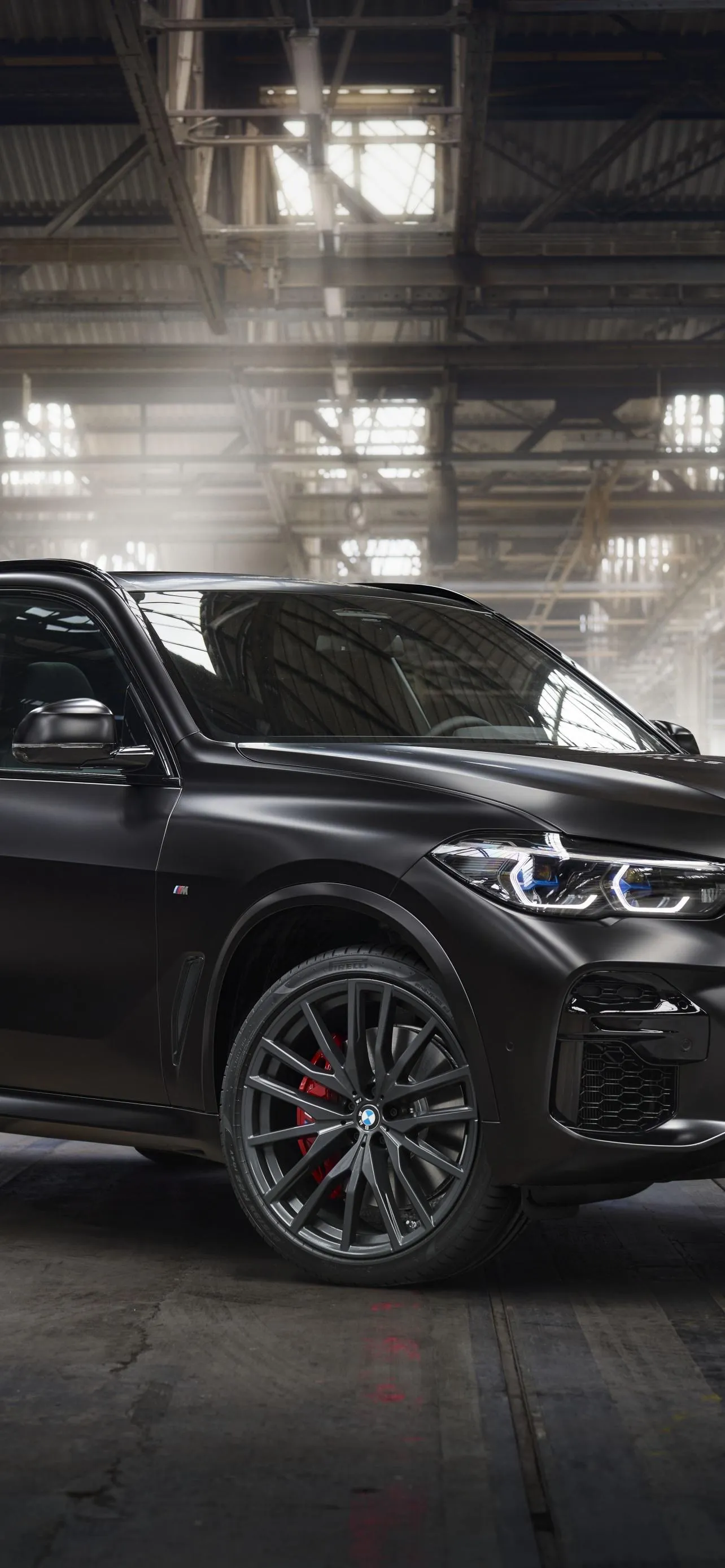 Black Bmw Suv Posed Inside a Dark Industrial Garage