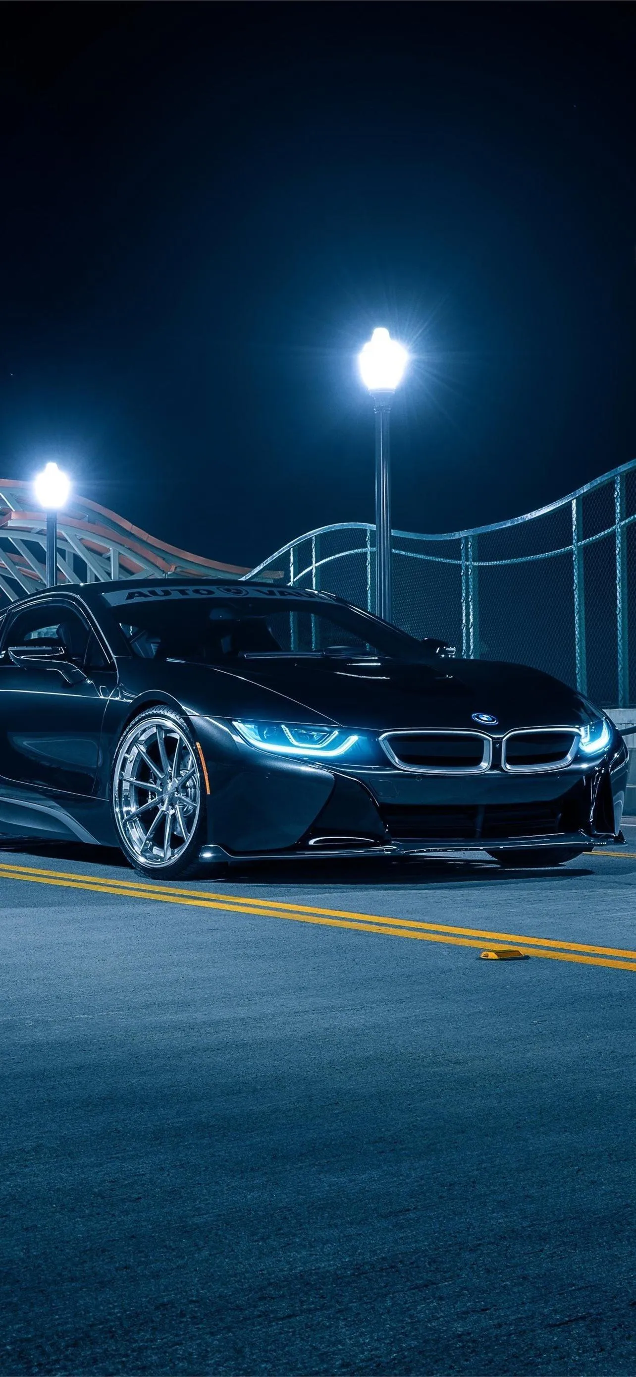 Black Bmw Under Street Lights in a Dark Urban Parking Area