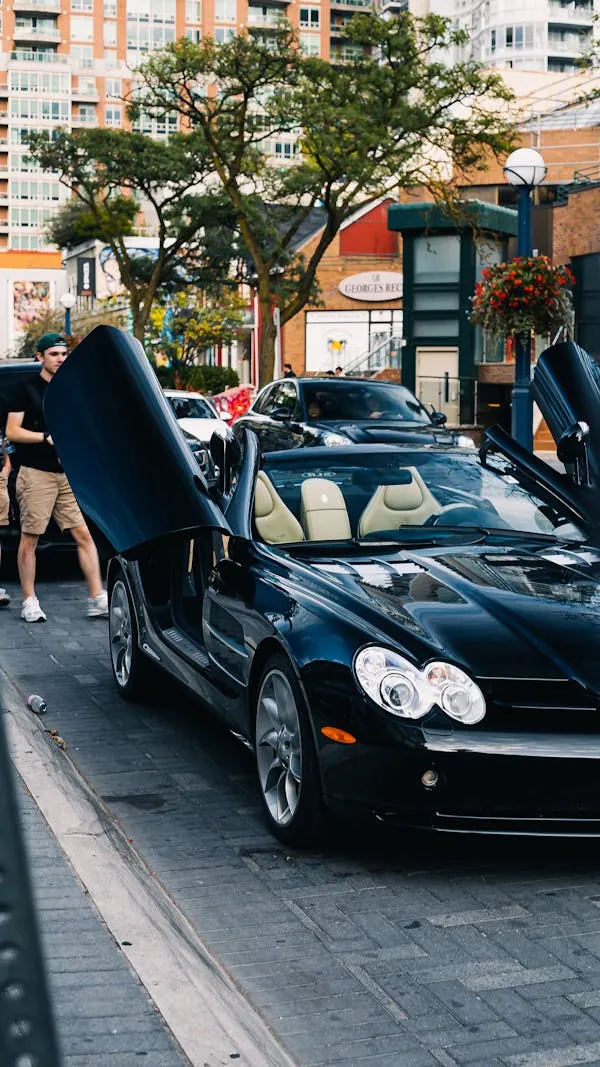 Black Convertible Mercedes With Door Open on Street