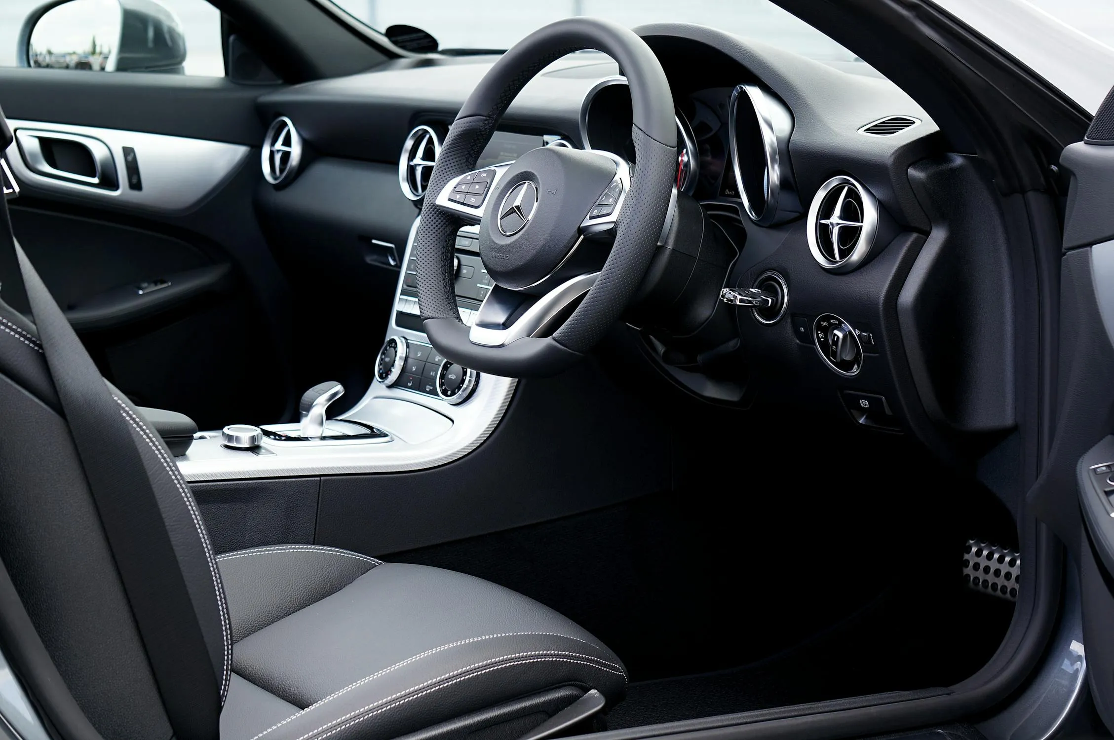 Black Leather Interior of New Mercedes Car Cabin Wallpaper