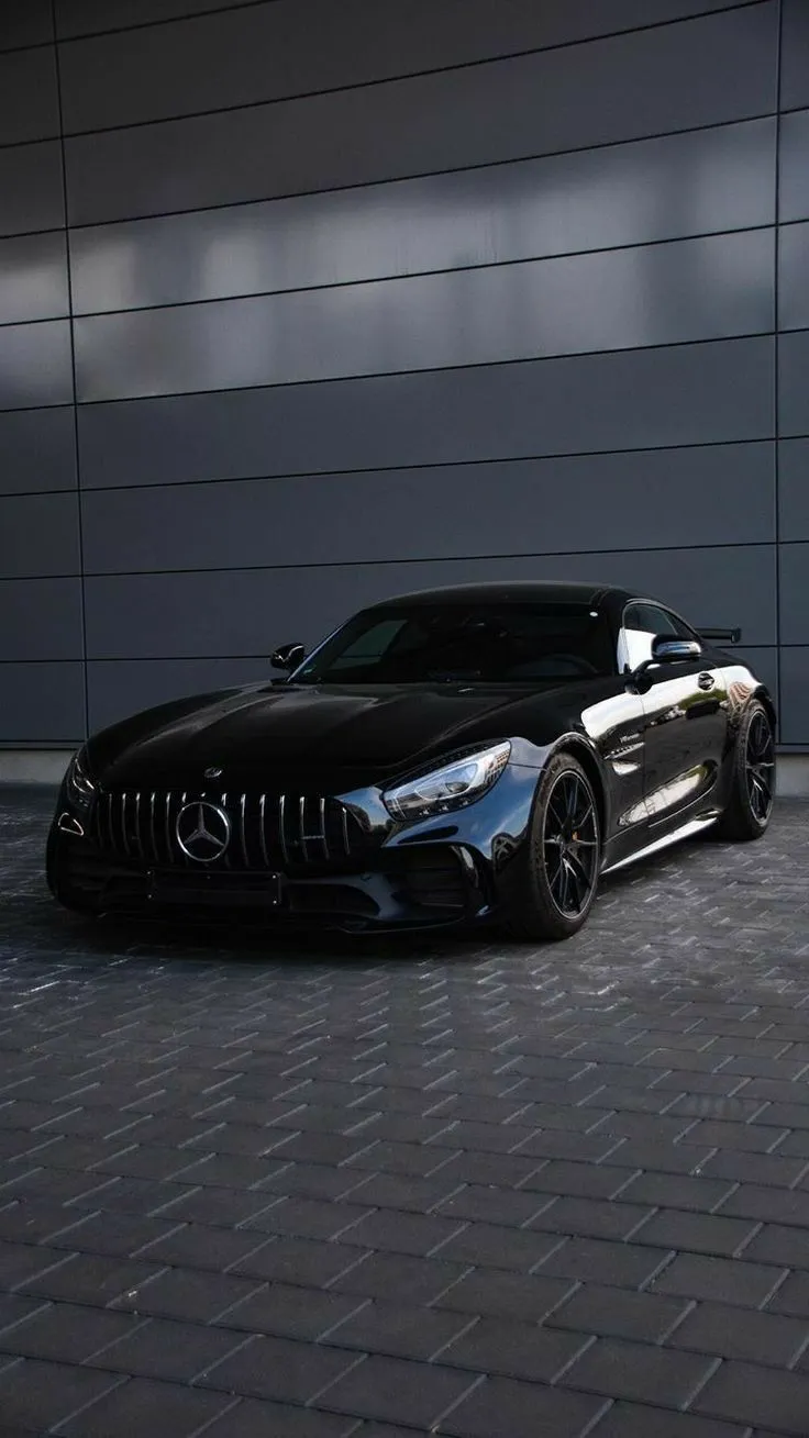 Black Mercedes AMG GT Parked by Modern Concrete Wall