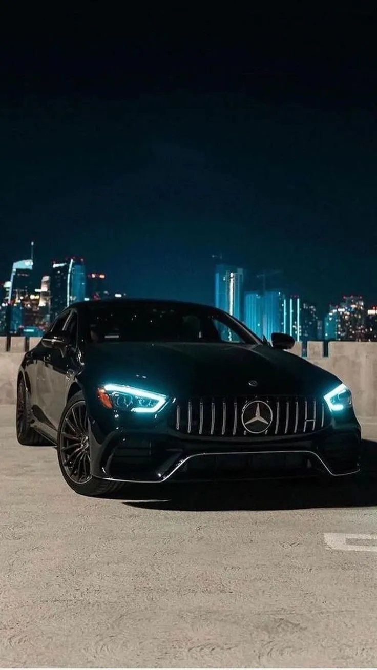 Black Mercedes AMG Parked at Night in Urban Location