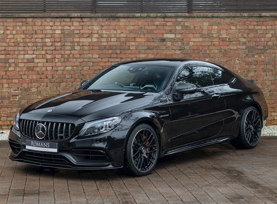 Black Mercedes AMG Sedan by Brick Wall free 4K Wallpaper