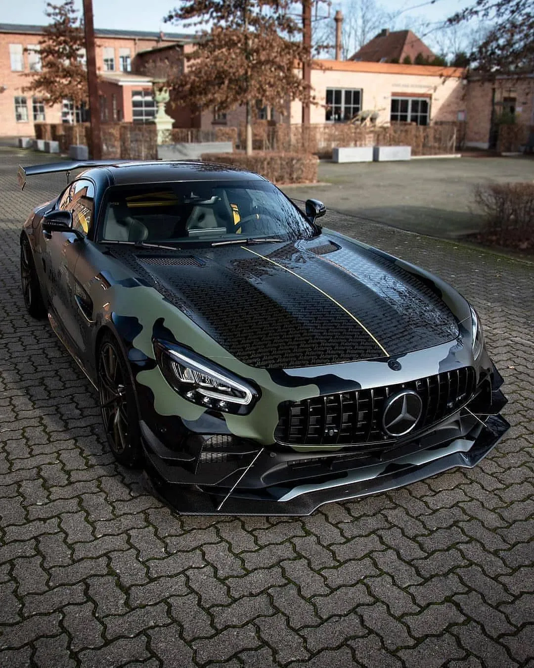 Black Mercedes Benz AMG Sports Car Parked on Brick Pavement