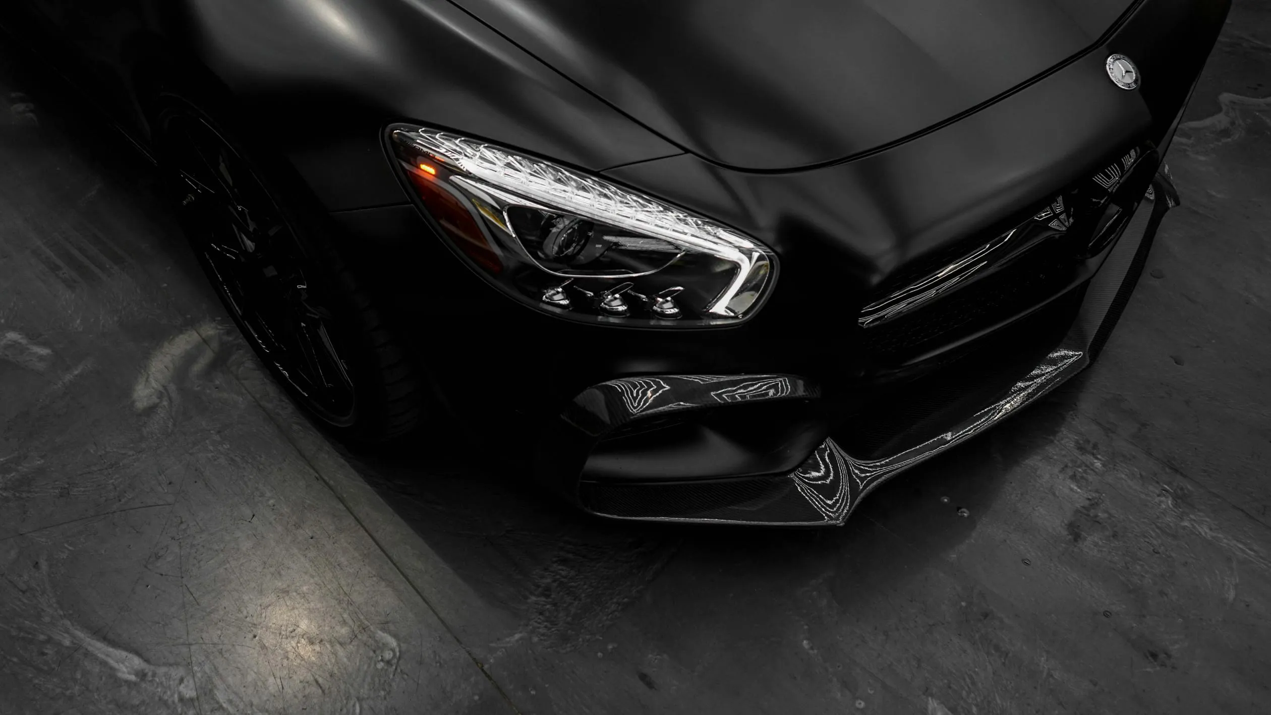 Black Mercedes Benz Car Front View in Dimly Lit Environment