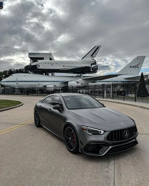 Black Mercedes Benz Car Parked Near Space Shuttle Exhibit
