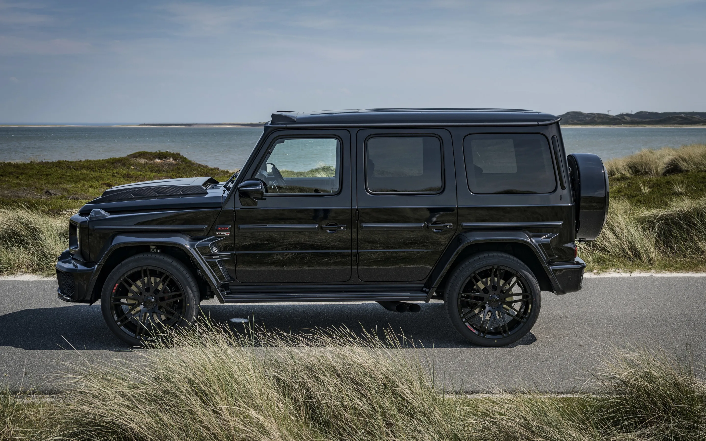 Black Mercedes Benz G Wagon Driving on Coastal Road
