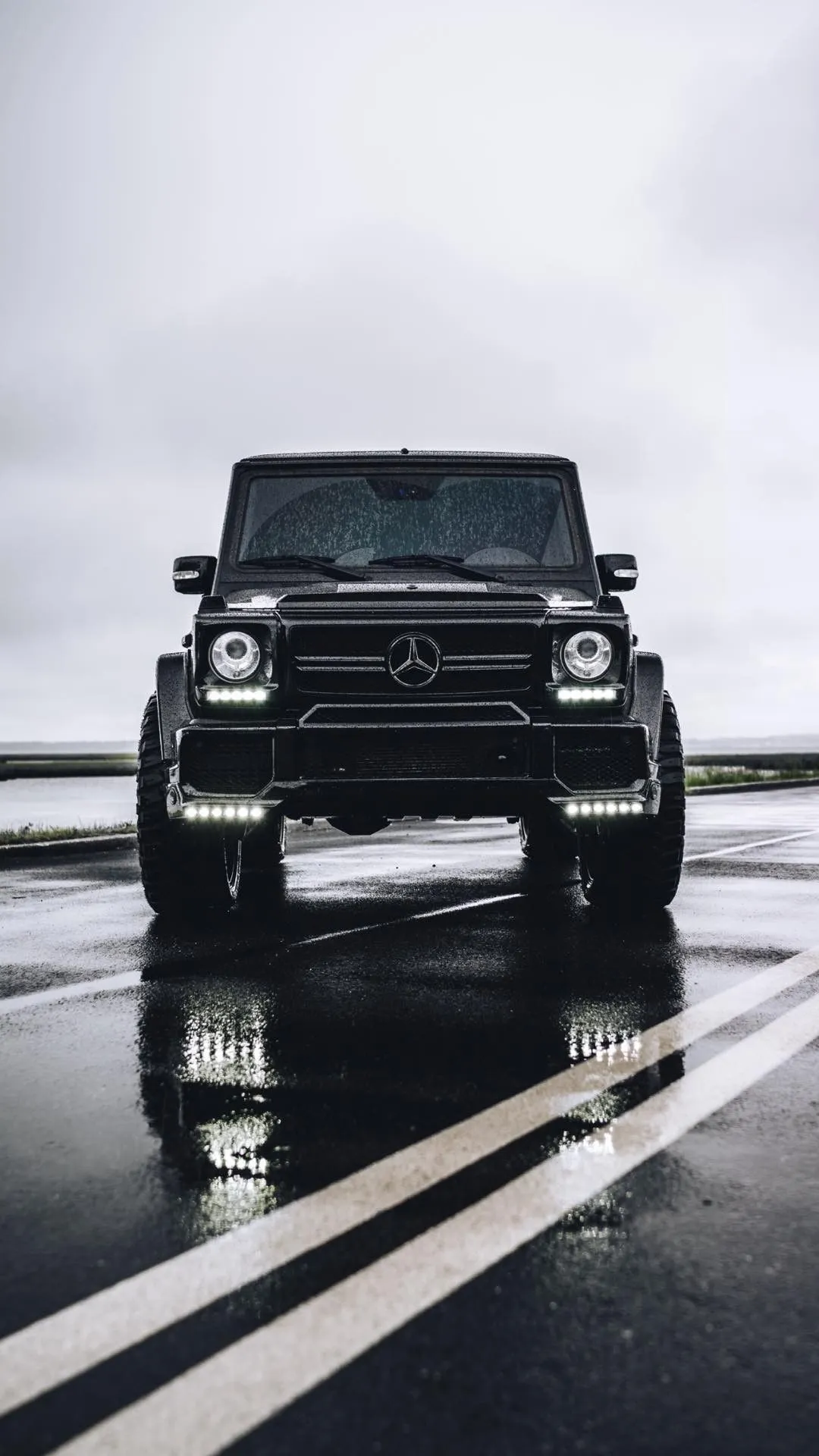 Black Mercedes Benz G Wagon Driving on Wet Road Wallpaper
