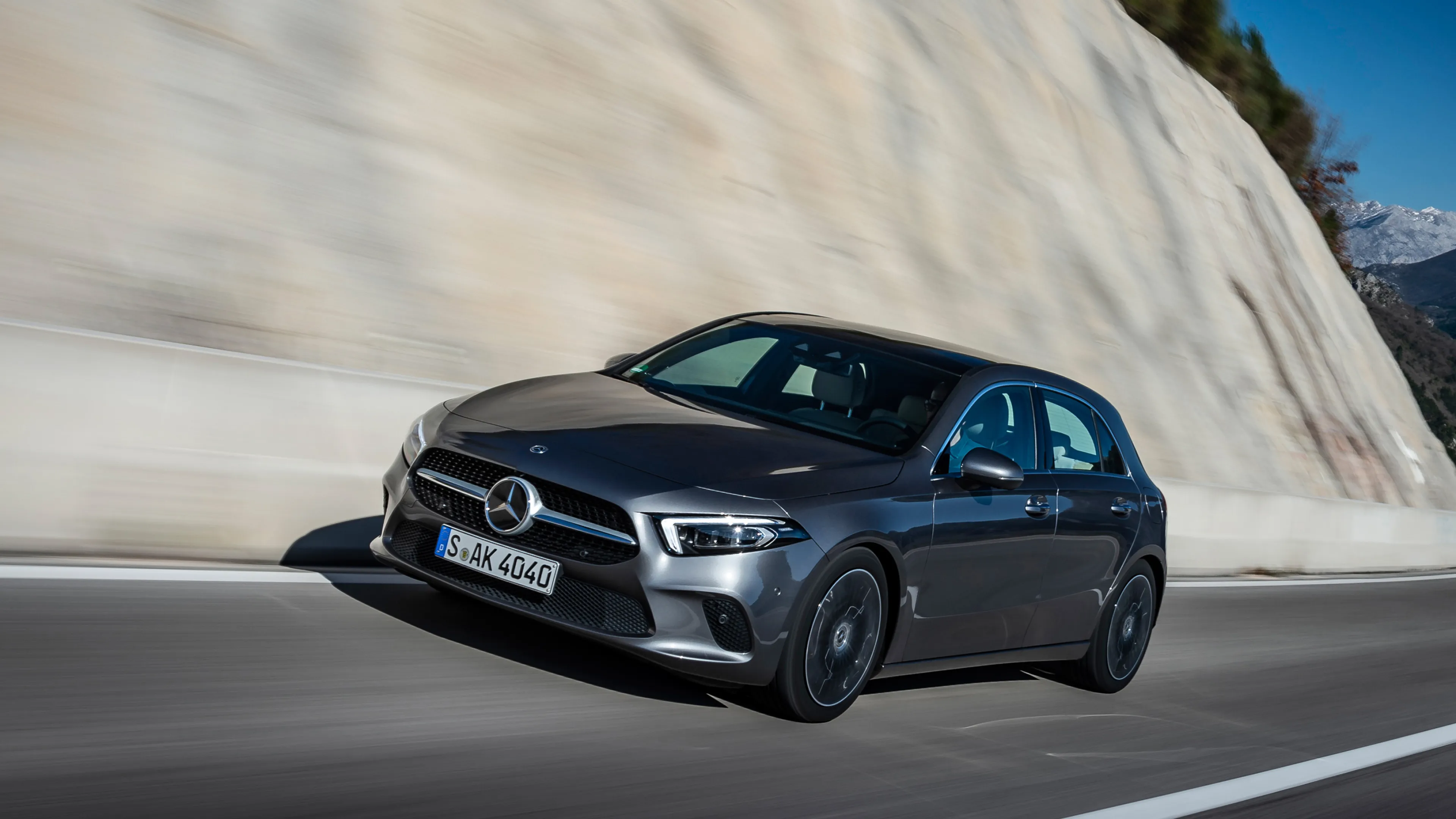 Black Mercedes Benz Hatchback Moving Fast on Open Road