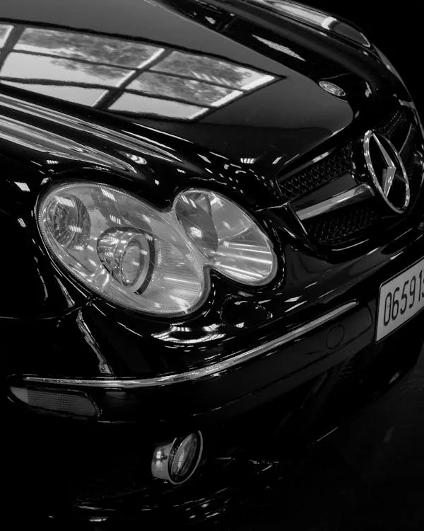 Black Mercedes Benz Headlight and Front Detail Close Up