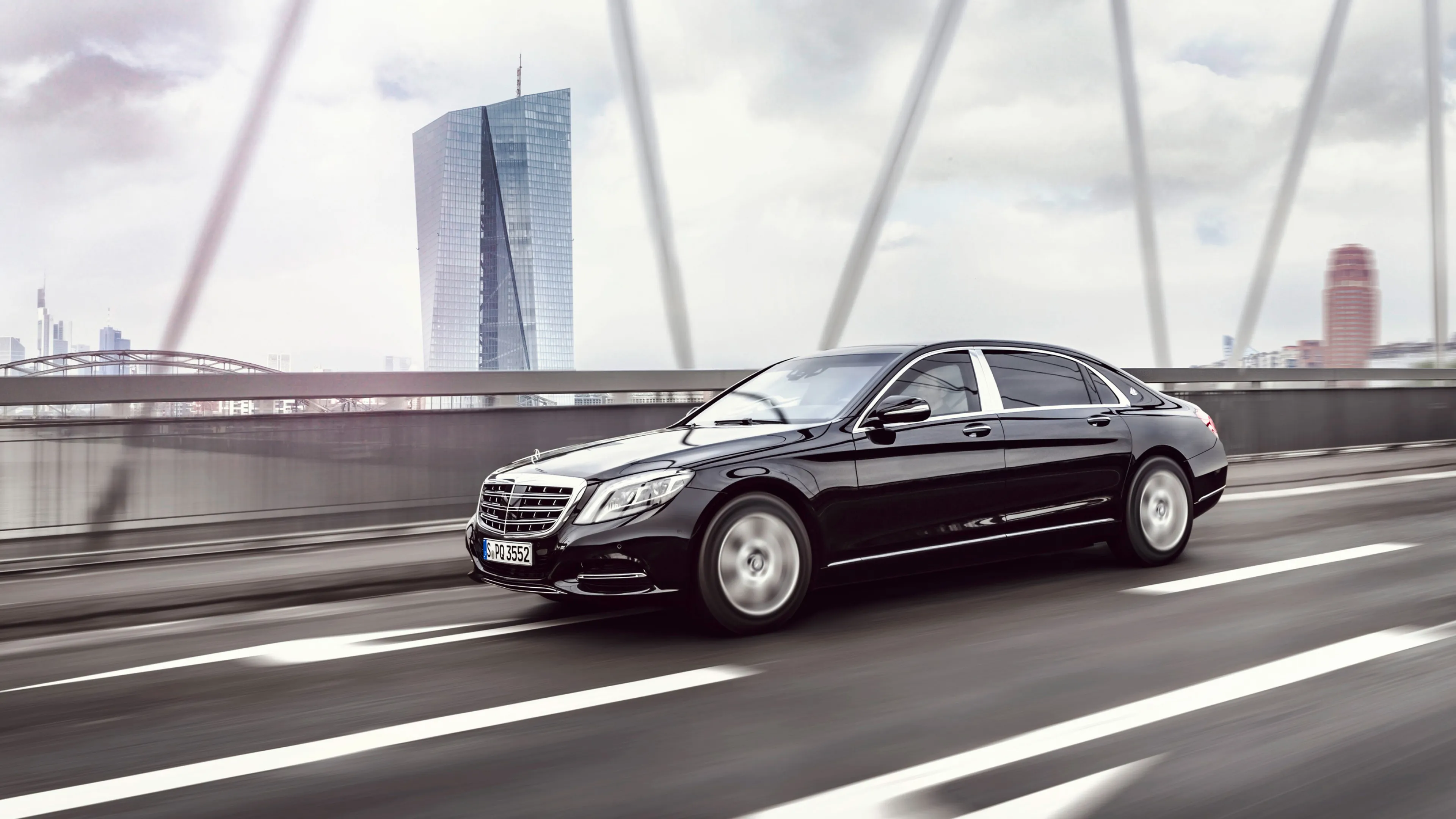 Black Mercedes Benz Luxury Sedan Driving on Bridge
