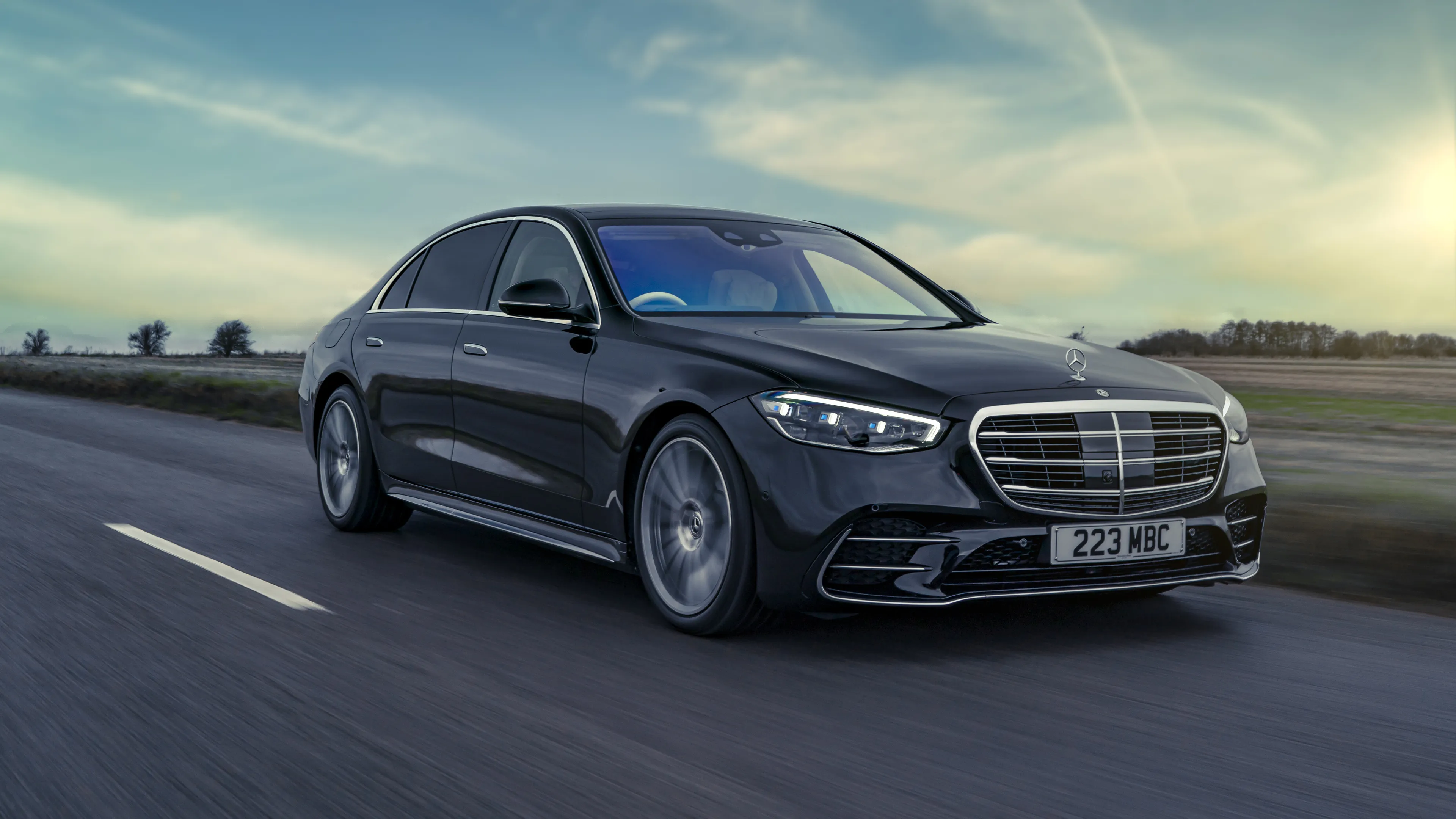 Black Mercedes Benz Luxury Sedan Driving on Highway