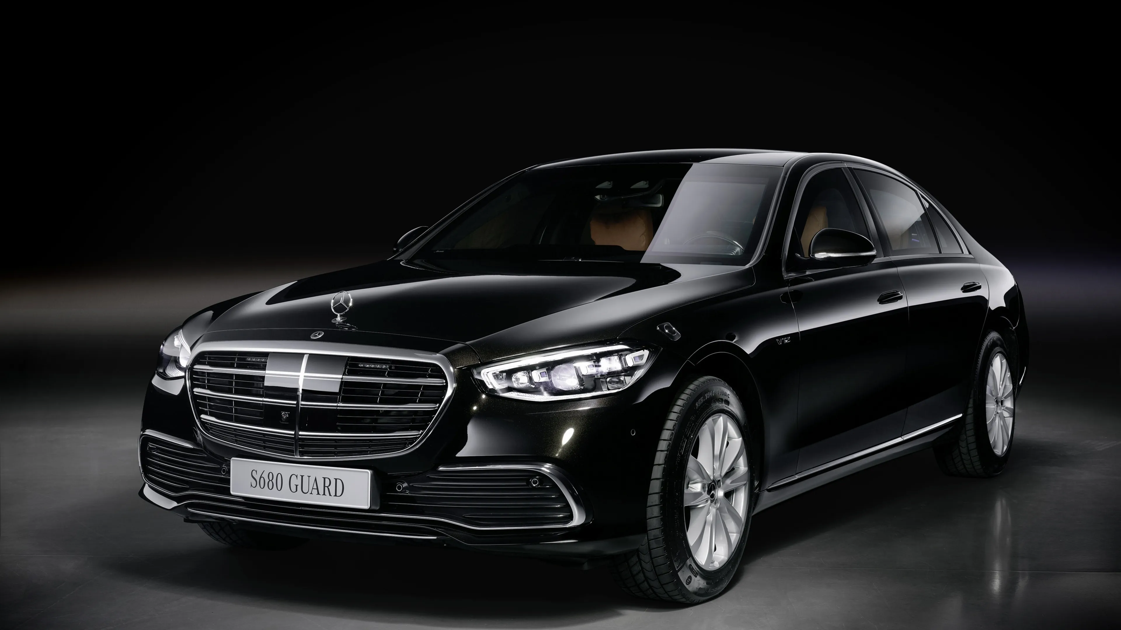 Black Mercedes Benz Luxury Sedan on Grey Indoor Floor