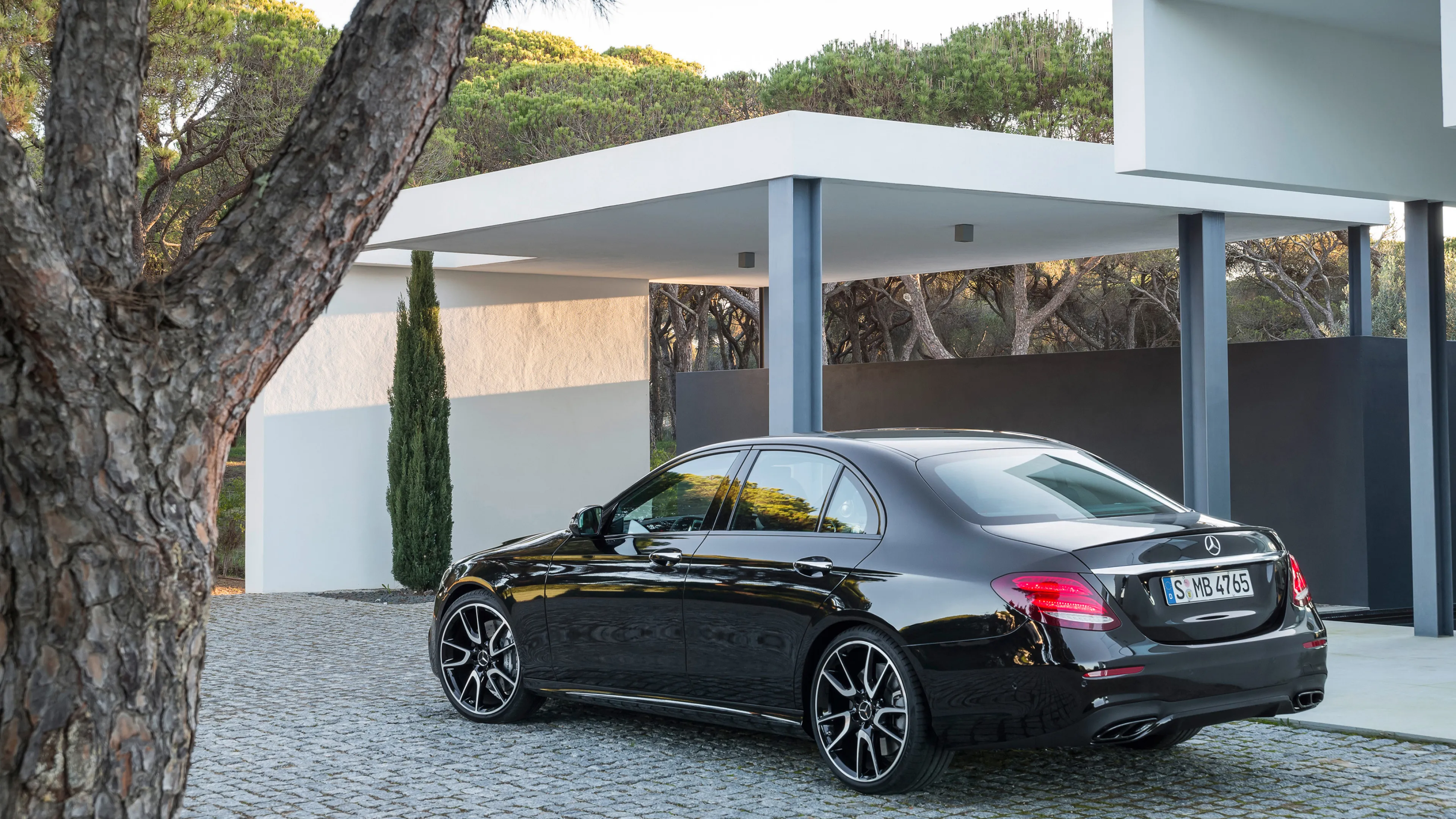 Black Mercedes Benz Sedan Parked by Modern House image