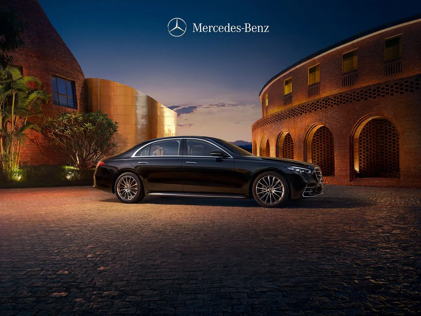 Black Mercedes Benz Sedan Parked Outside Building at Night