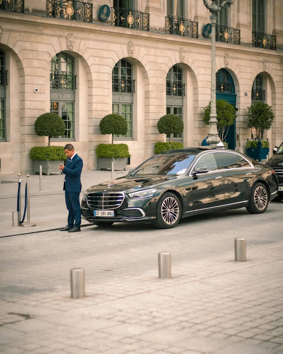 Black Mercedes Benz Sedan Parked Outside Historic Building
