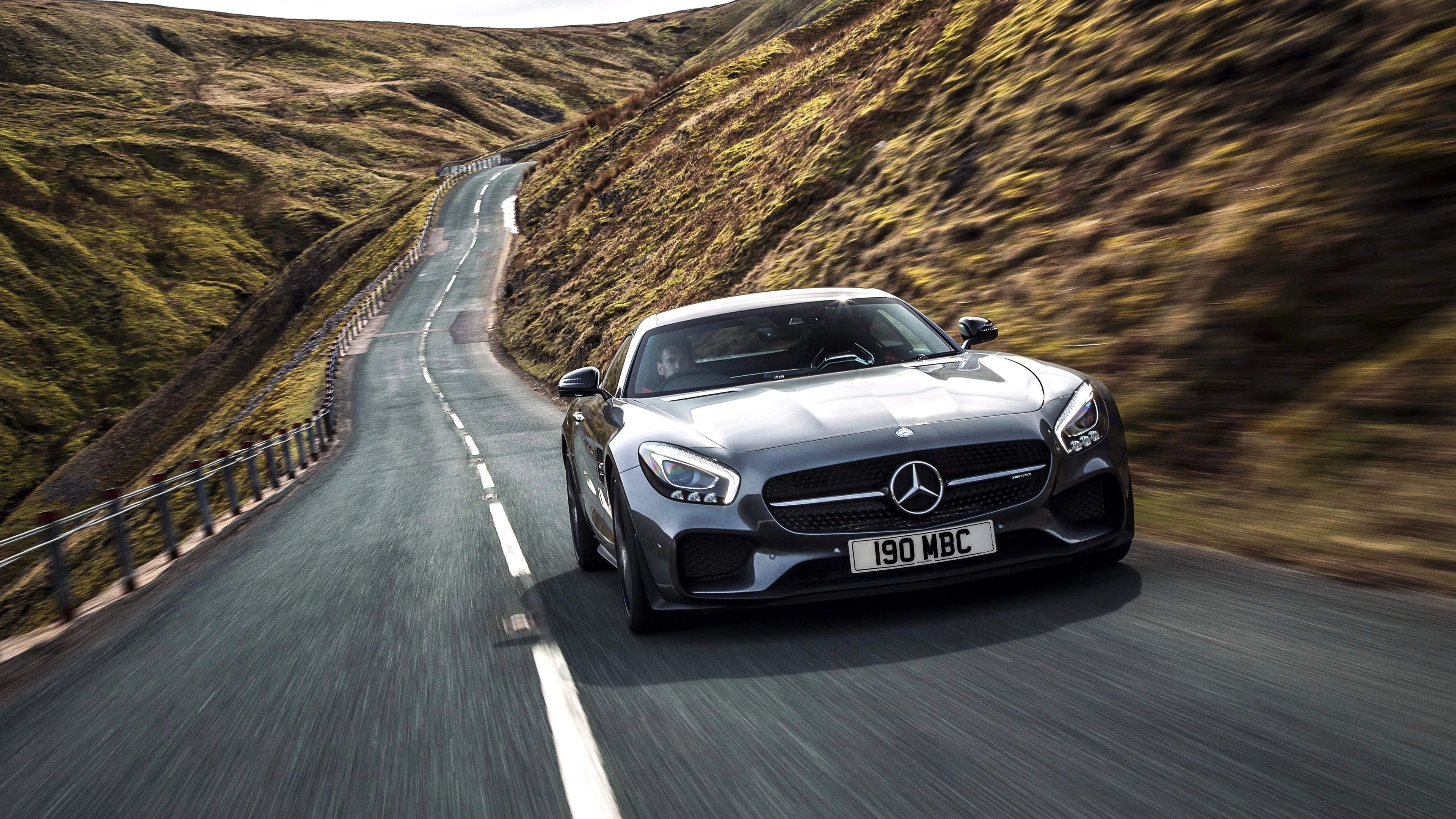 Black Mercedes Benz Sports Car Driving on Winding Road