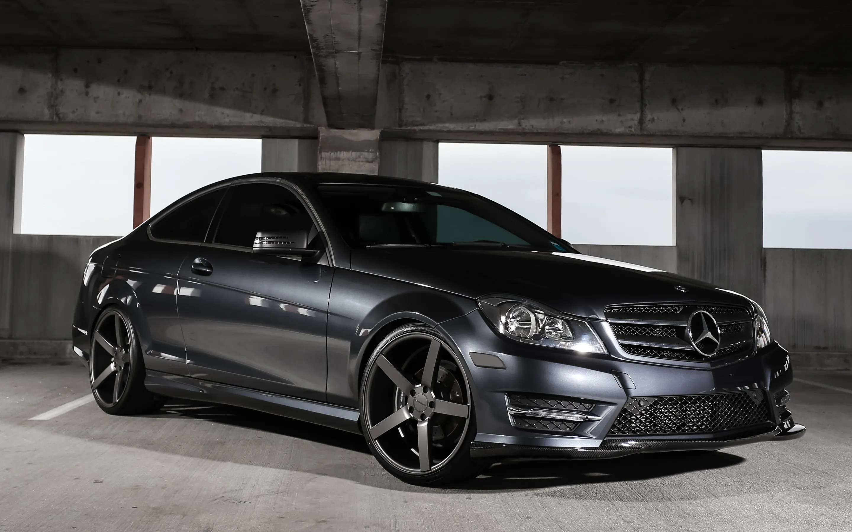 Black Mercedes Benz Sports Sedan Parked in Urban Garage