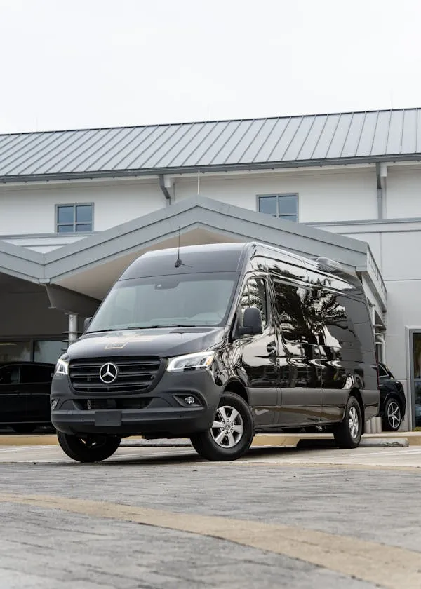 Black Mercedes Benz Van Parked Outside Building Wallpaper