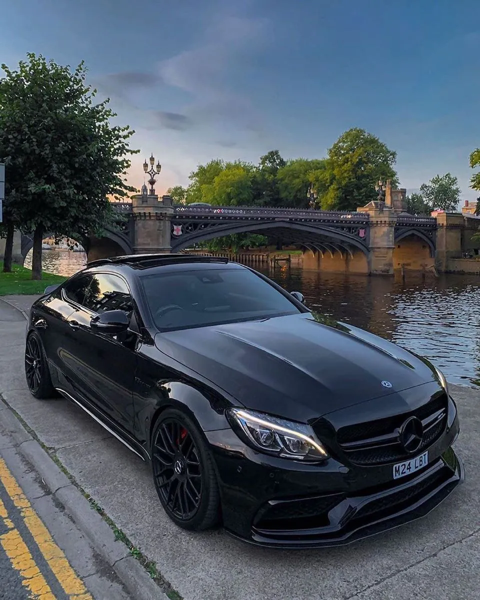 Black Mercedes Coupe Posed on Riverside Evening Road