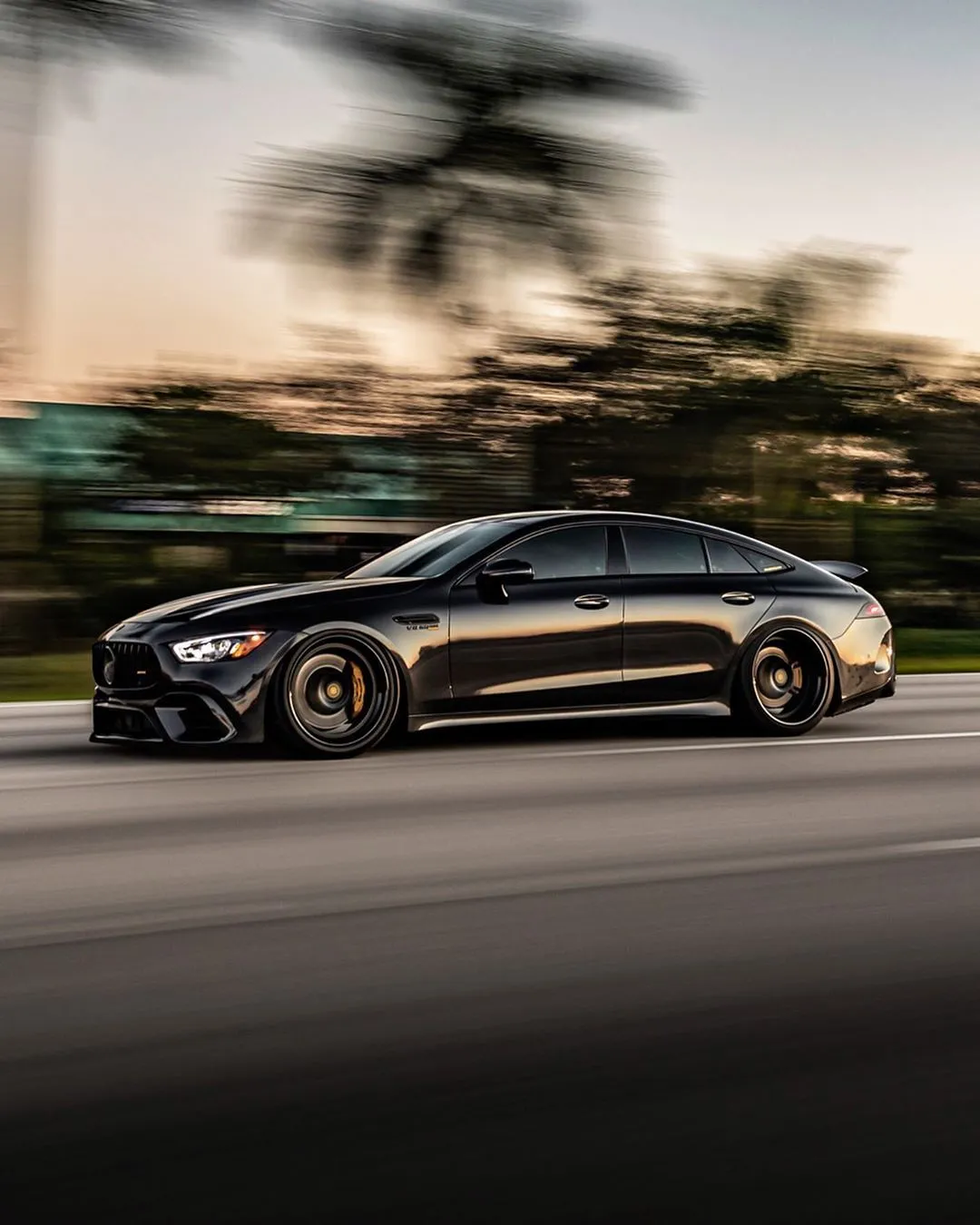 Black Mercedes Driving Fast on Road During Sunset Hour