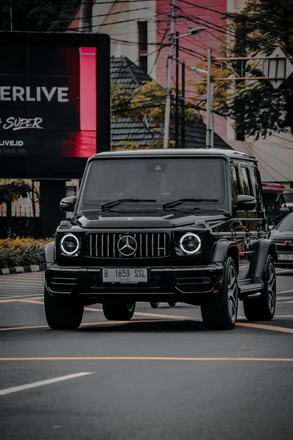 Black Mercedes G Class Driving Through Busy Street image