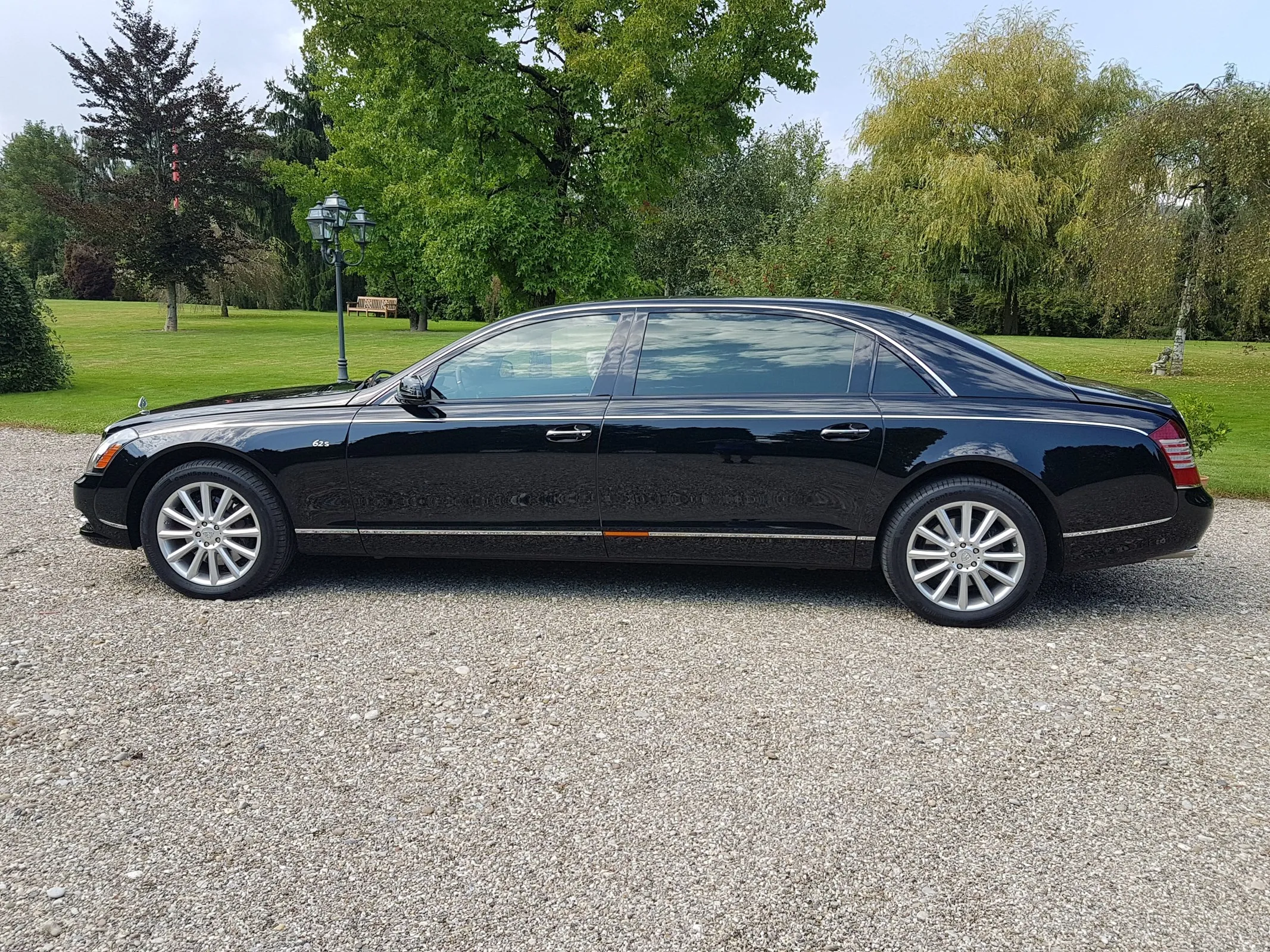 Black Mercedes Luxury Sedan Parked on Gravel Driveway