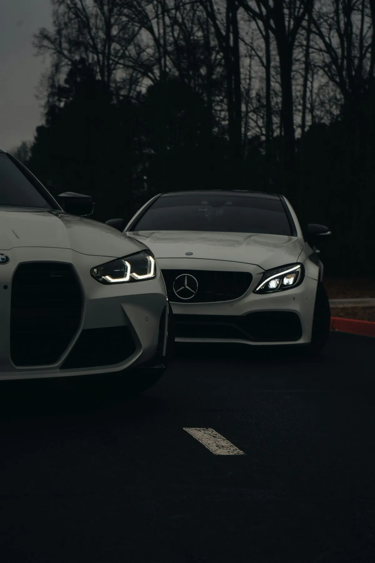 Black Mercedes Parked Beside White Sports Car Outdoors