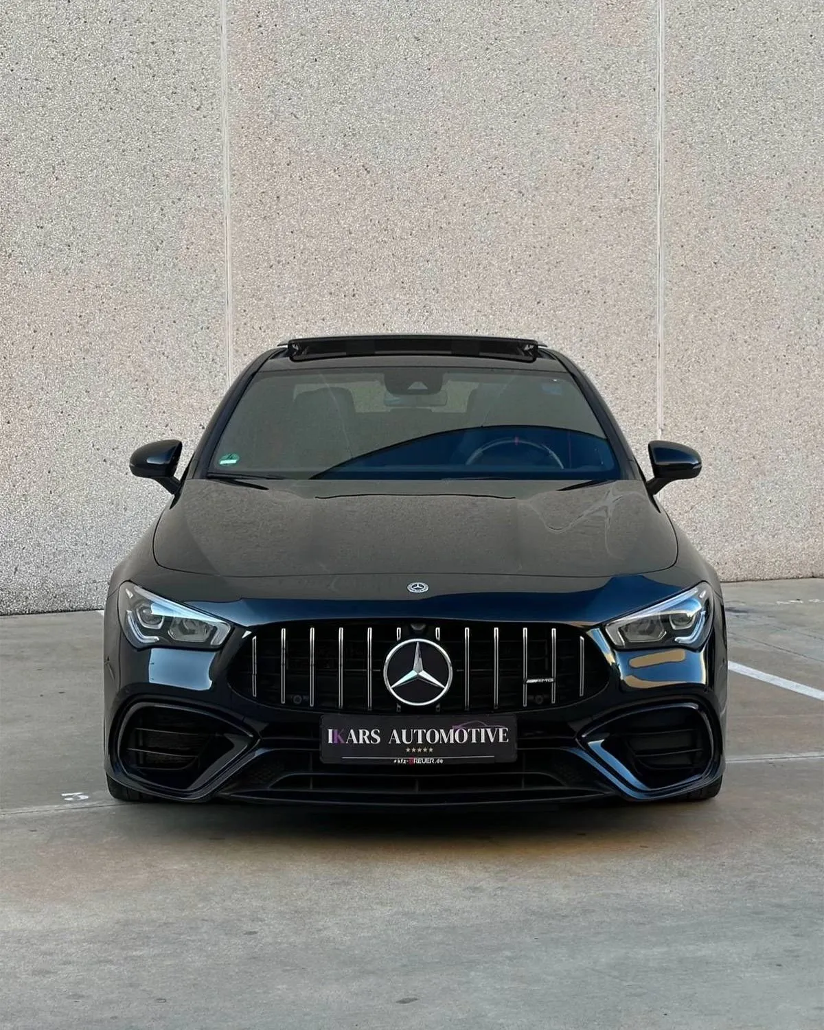 Black Mercedes Parked Neatly by Concrete Wall Wallpaper