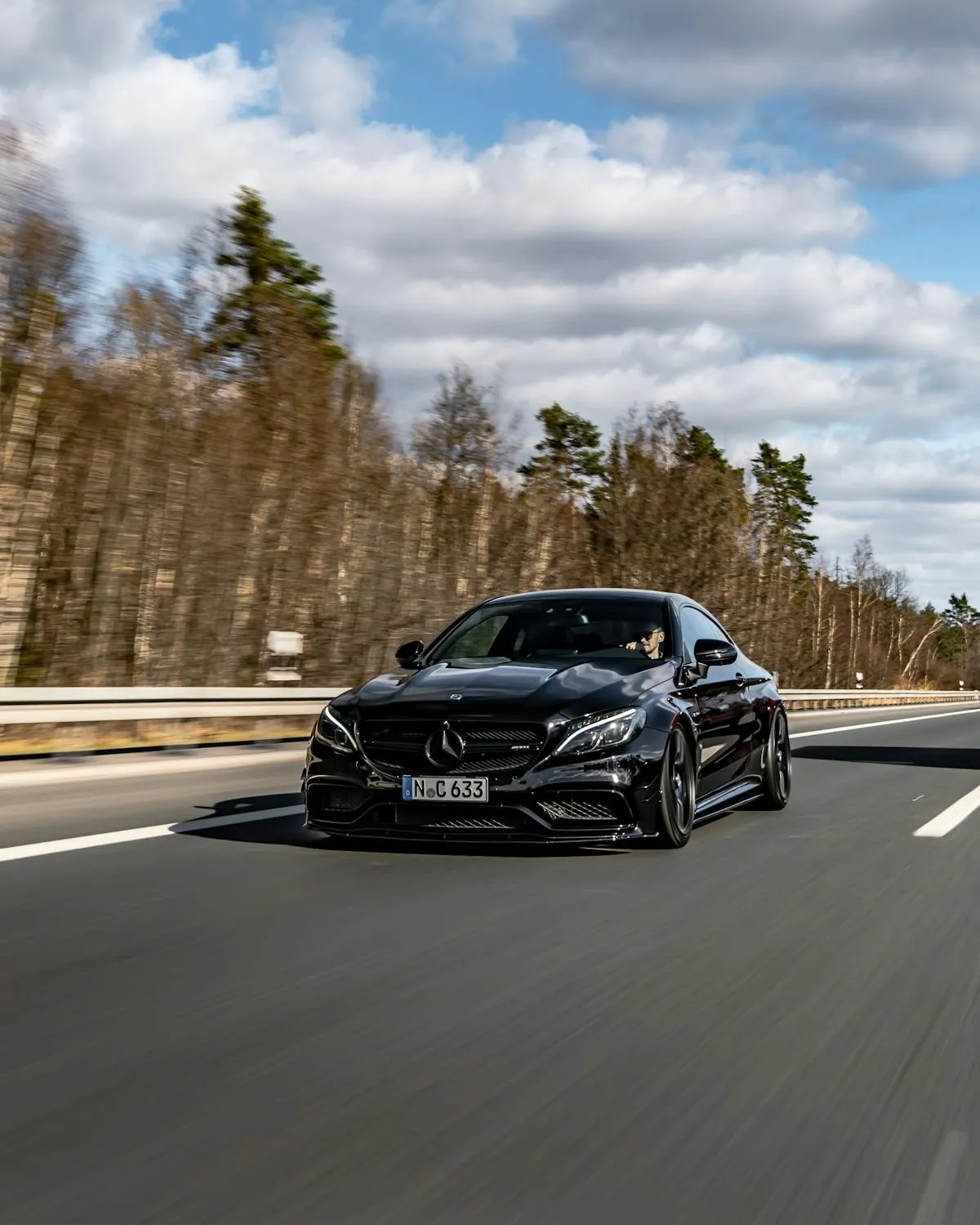 Black Mercedes Speeding on Open Highway Road Wallpaper