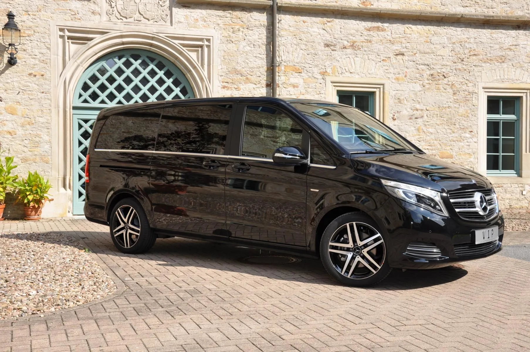 Black Mercedes Van Parked In Front Of Old Building 4K image