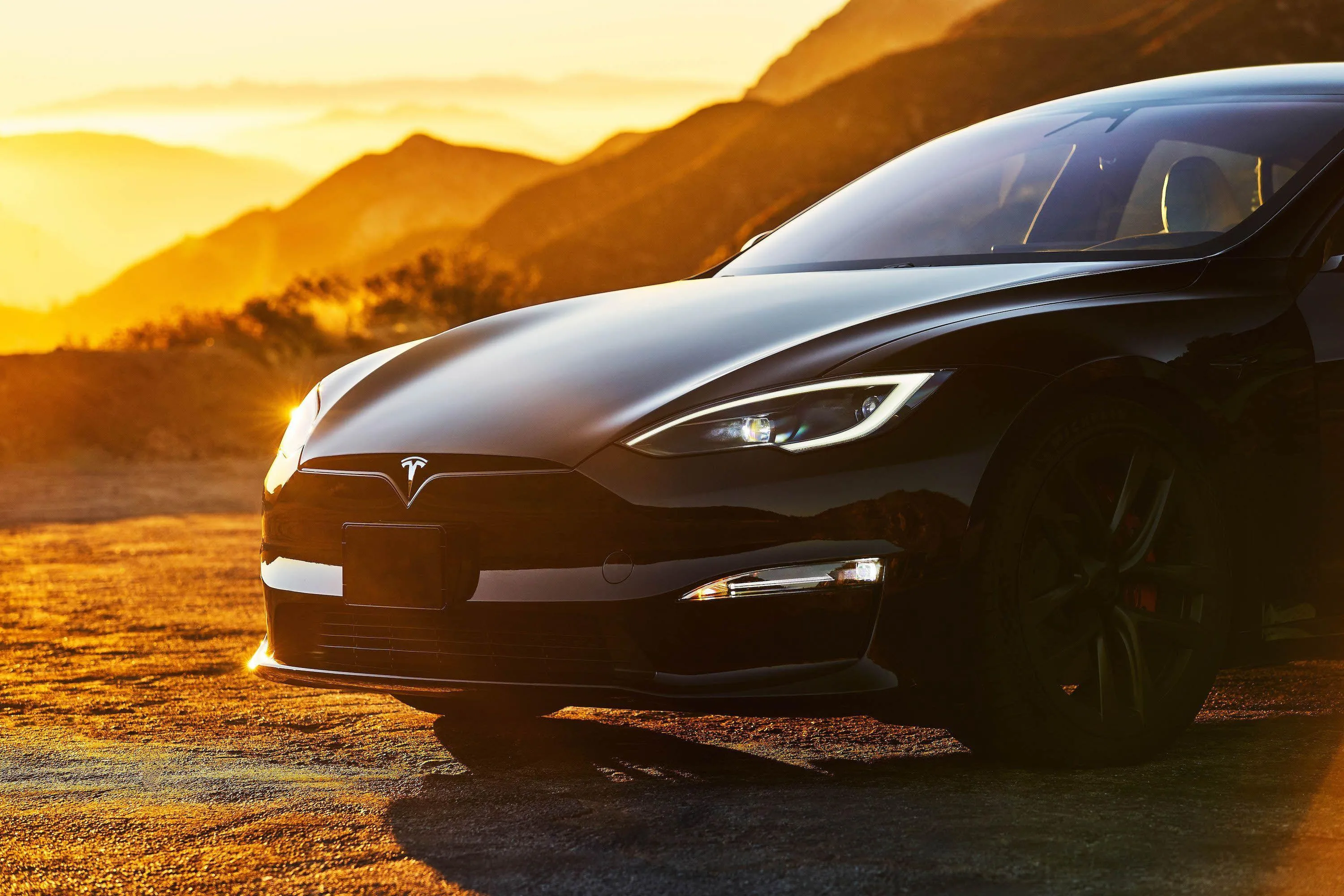 Black Tesla Model S Electric Car with Golden Sunset Glow