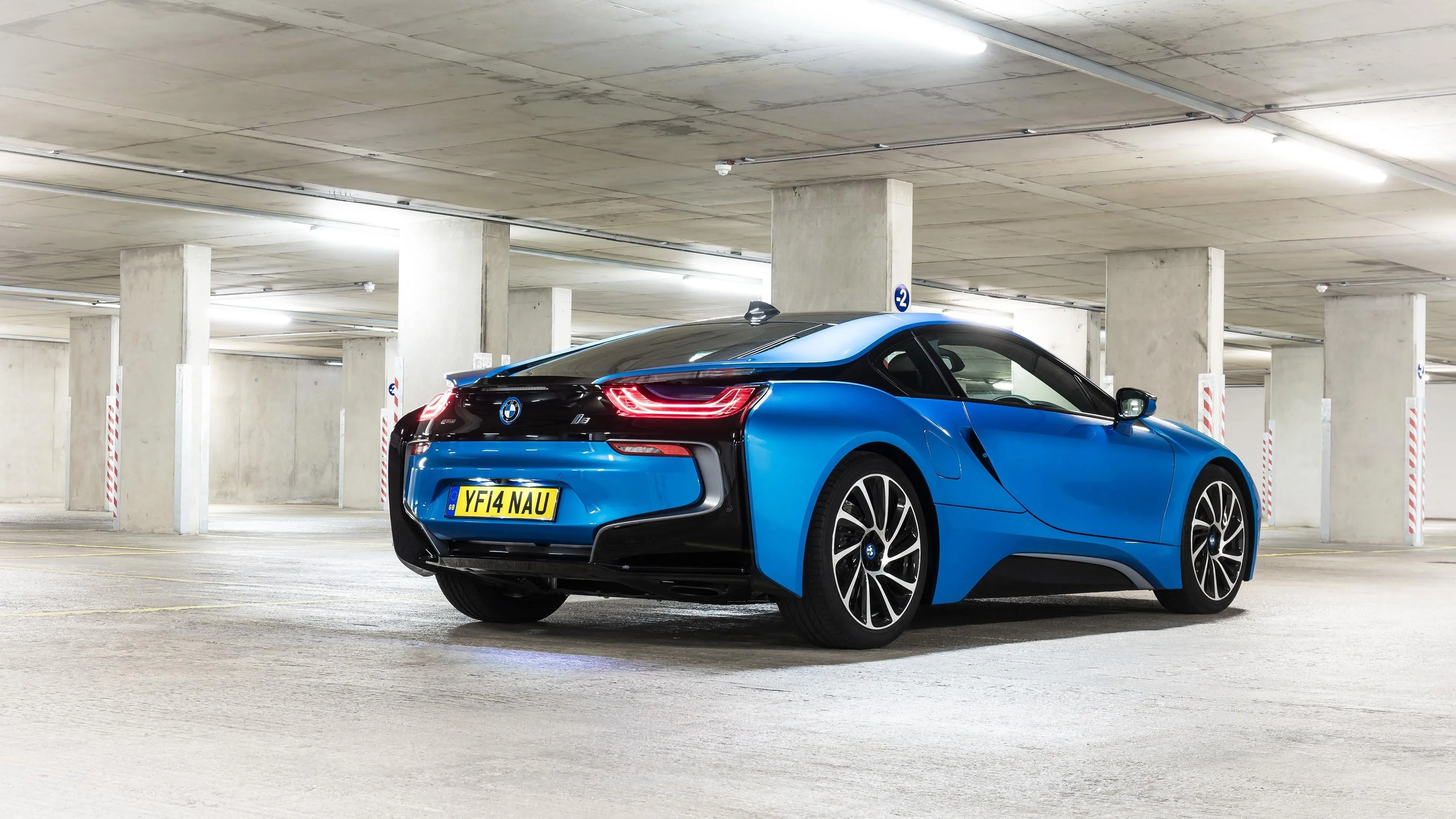 Blue and Black Bmw I8 Parked in White Underground Garage