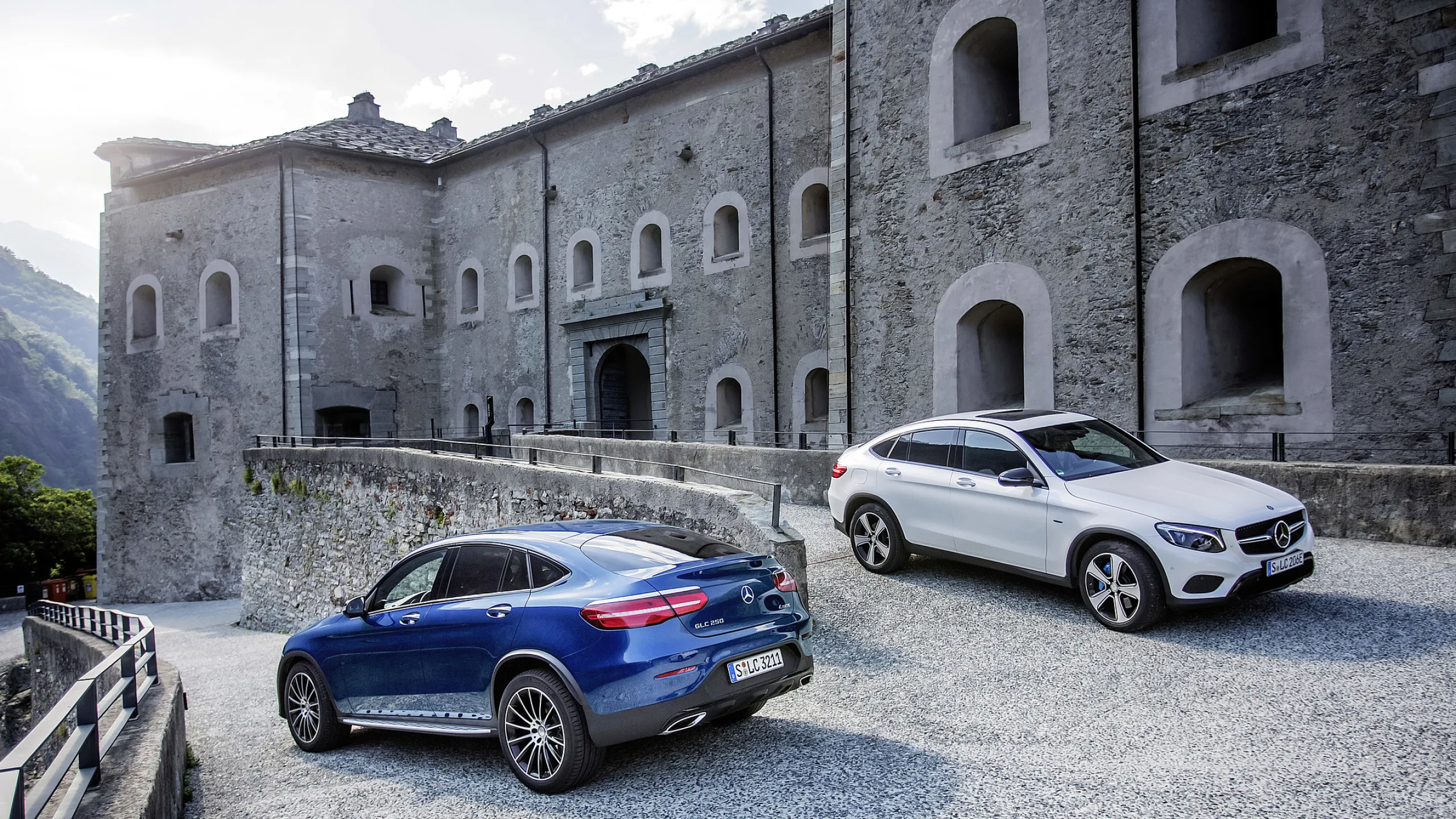 Blue and White Mercedes Benz SUVs Parked at Historic Site