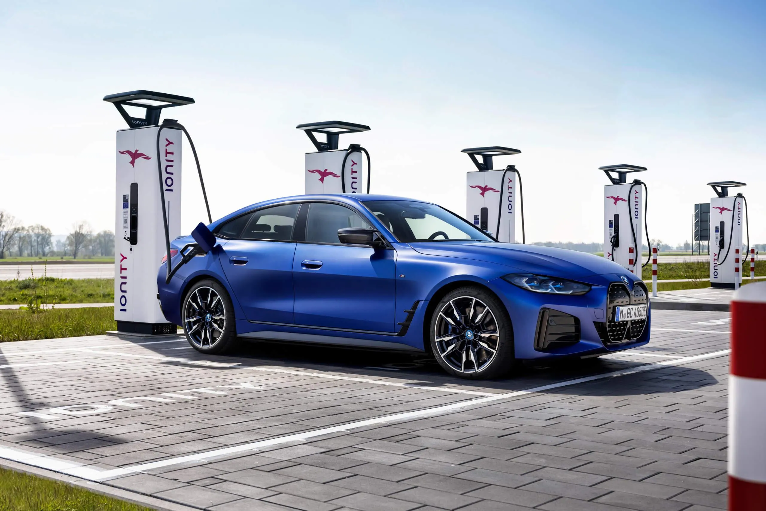 Blue Bmw Charging at Electric Station in Daylight Image