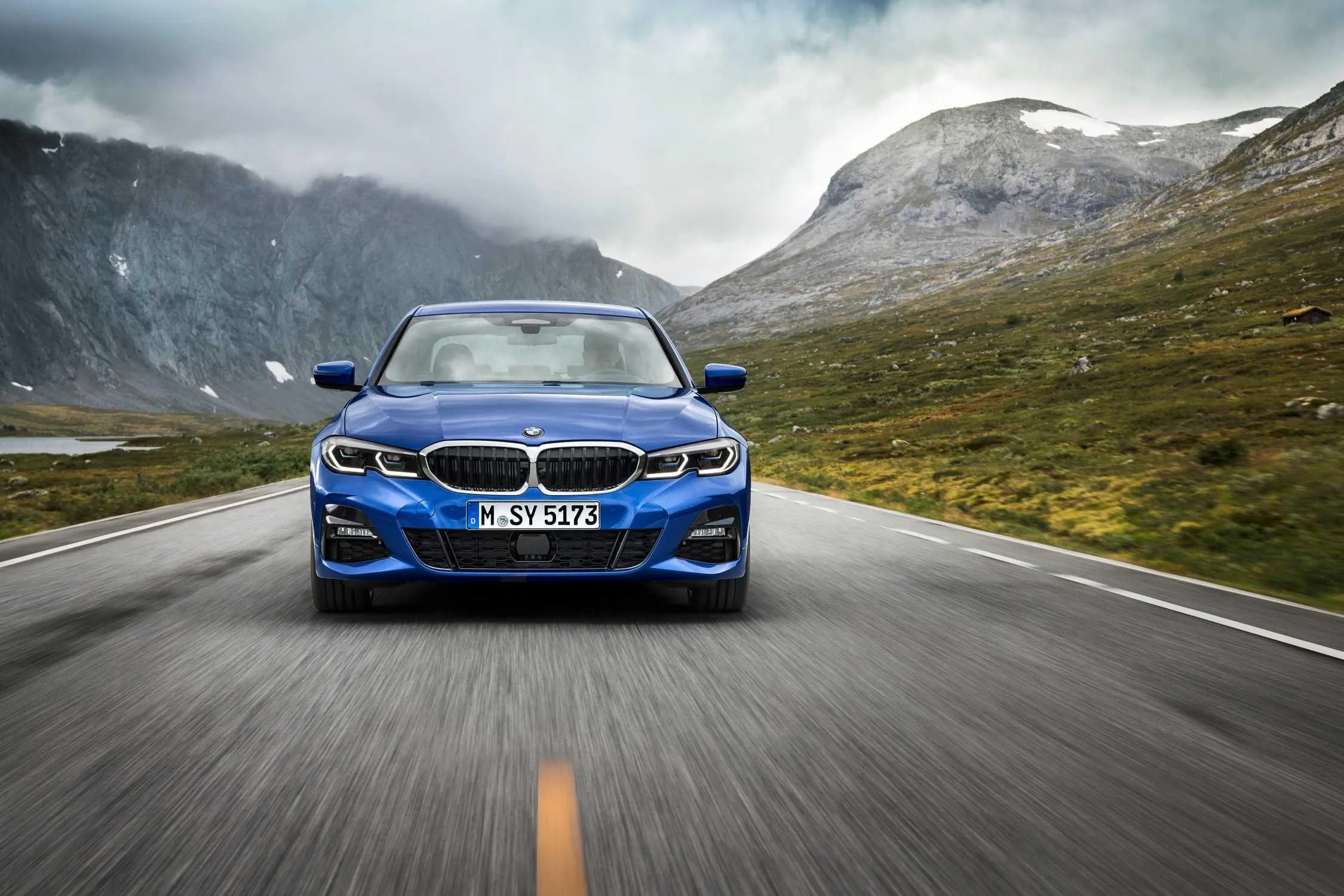 Blue Bmw Driving on Curvy Mountain Road at High Speed