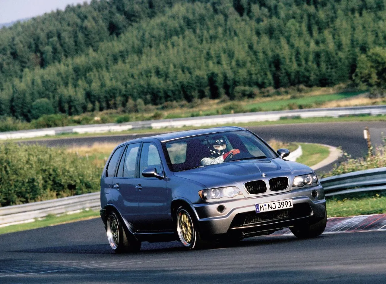 Blue Bmw Hatchback Driving on Scenic Mountain Road