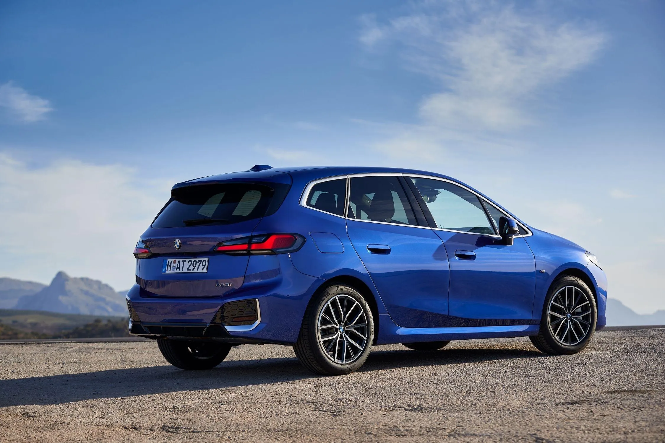 Blue Bmw Hatchback Parked in Open Area with Clear Sky