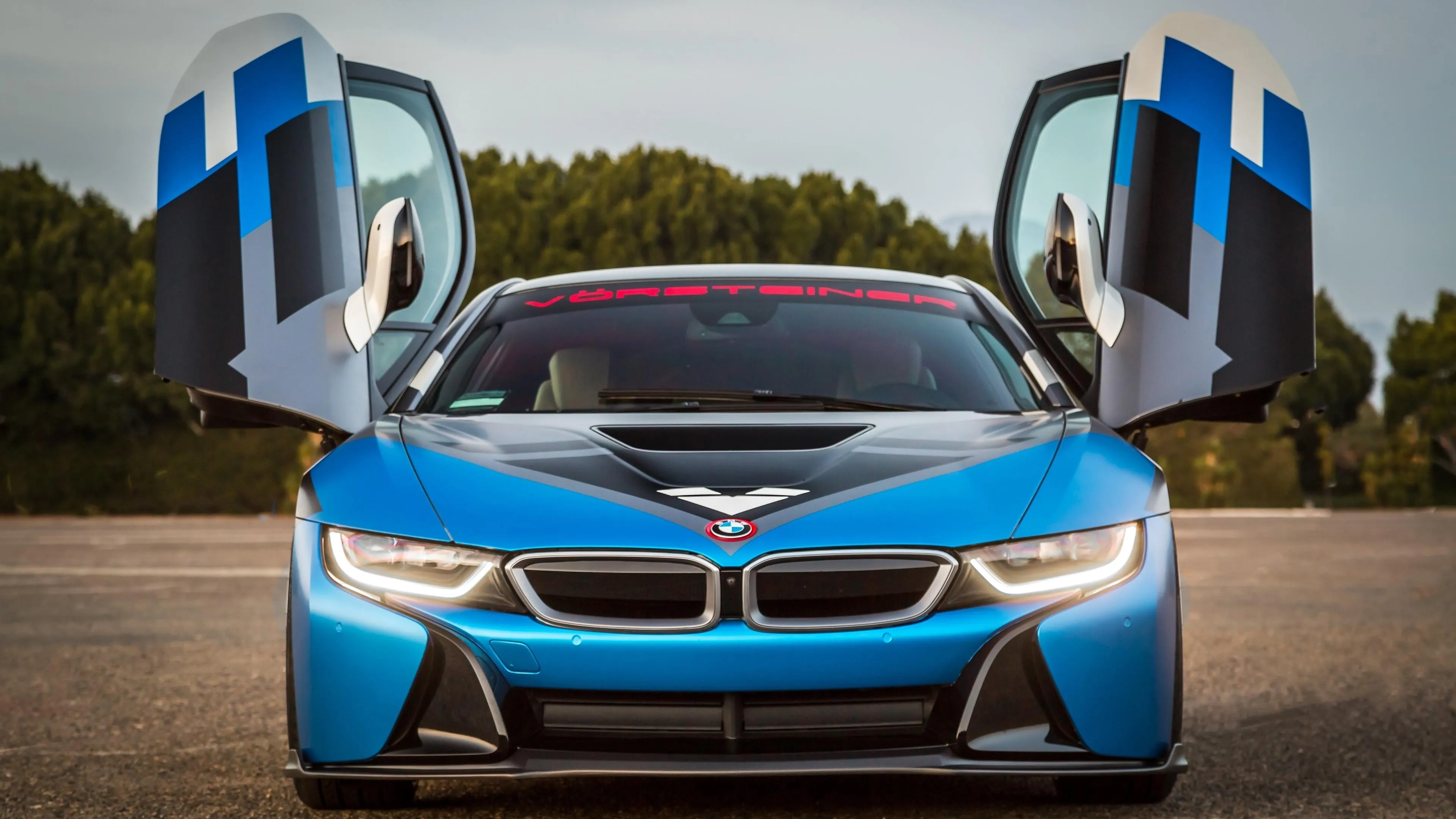 Blue Bmw I8 with Scissor Doors Open Under Bright Lights