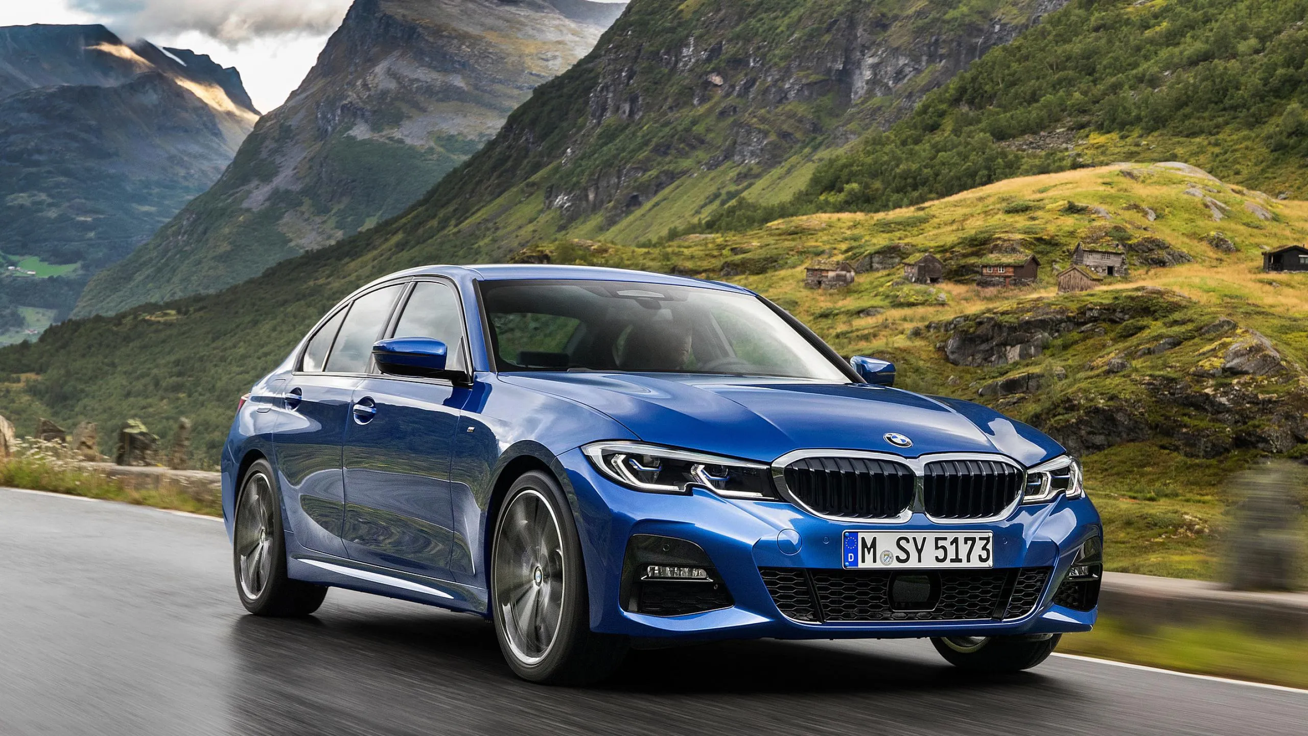 Blue Bmw on Scenic Road with Grassy Hills and Mountains