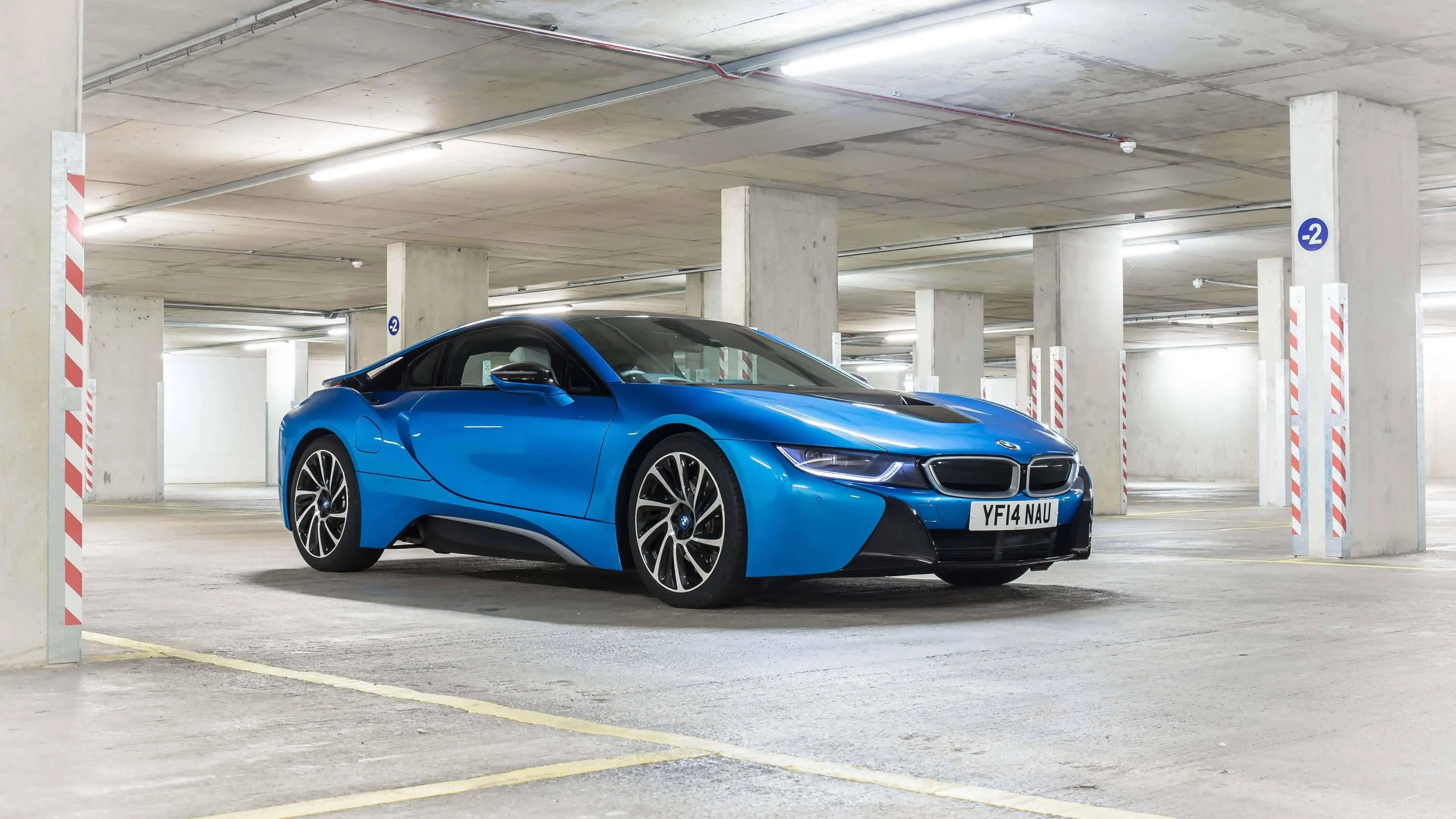 Blue Bmw Parked in Clean Bright White Indoor Garage
