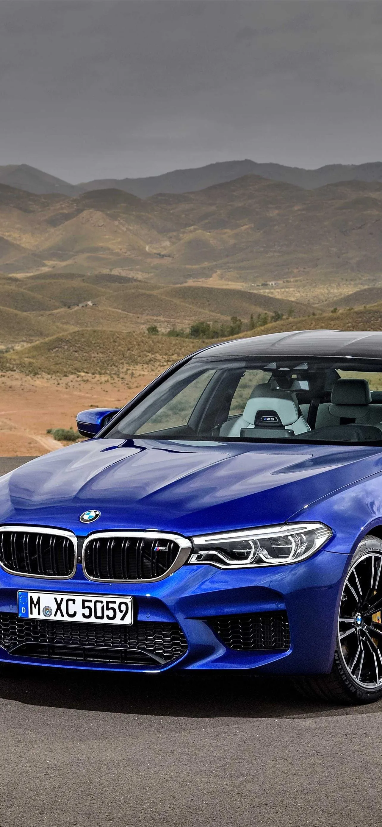 Blue Bmw Parked on Roadside in Desert Mountain Region